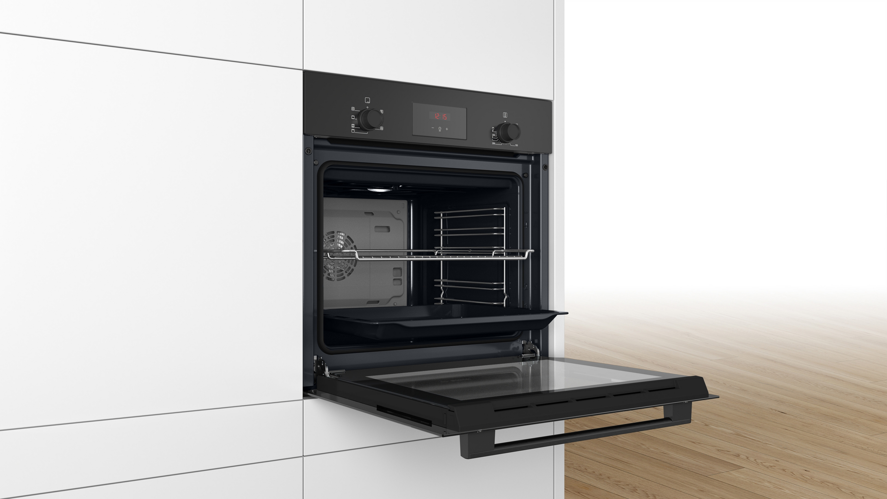 Oven door open. Inside shows racks and a tray. White kitchen.