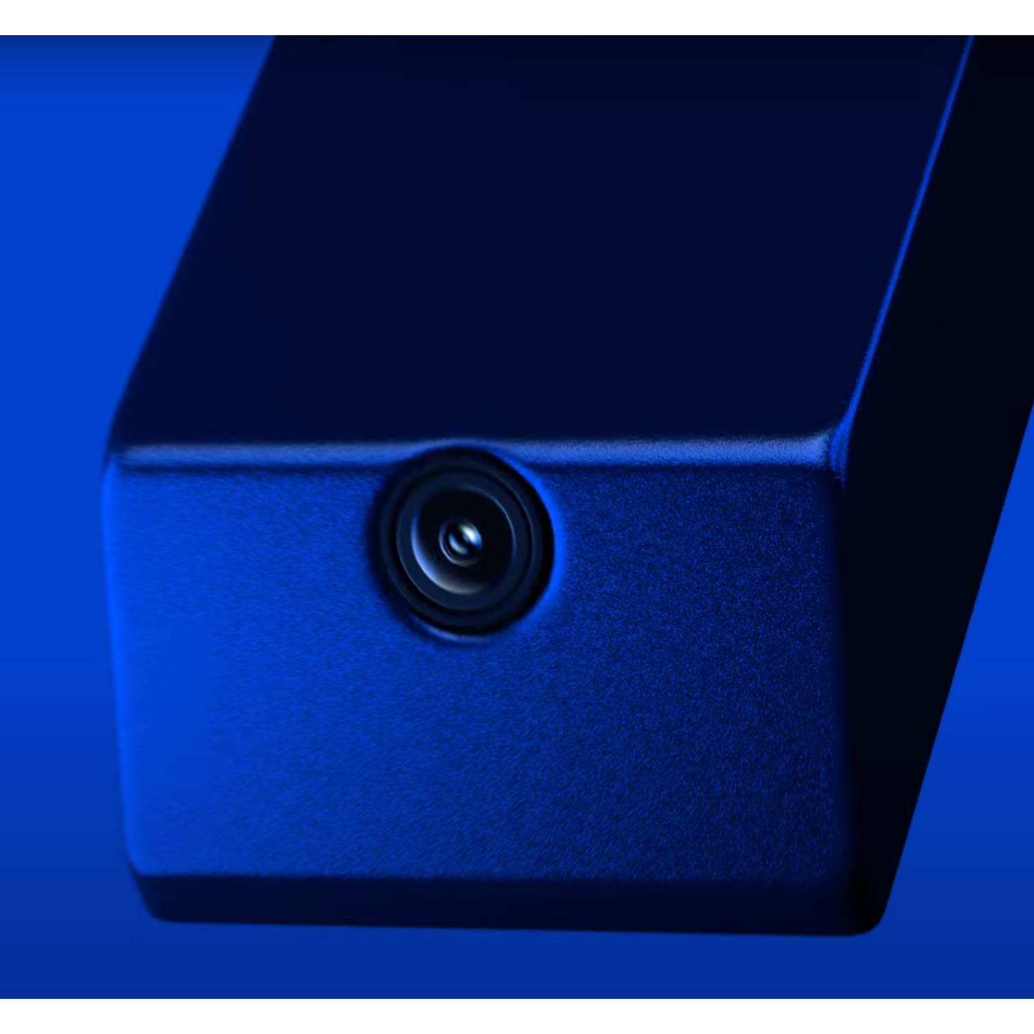 Blue camera with a single lens in the center. It is mounted on a blue surface.
