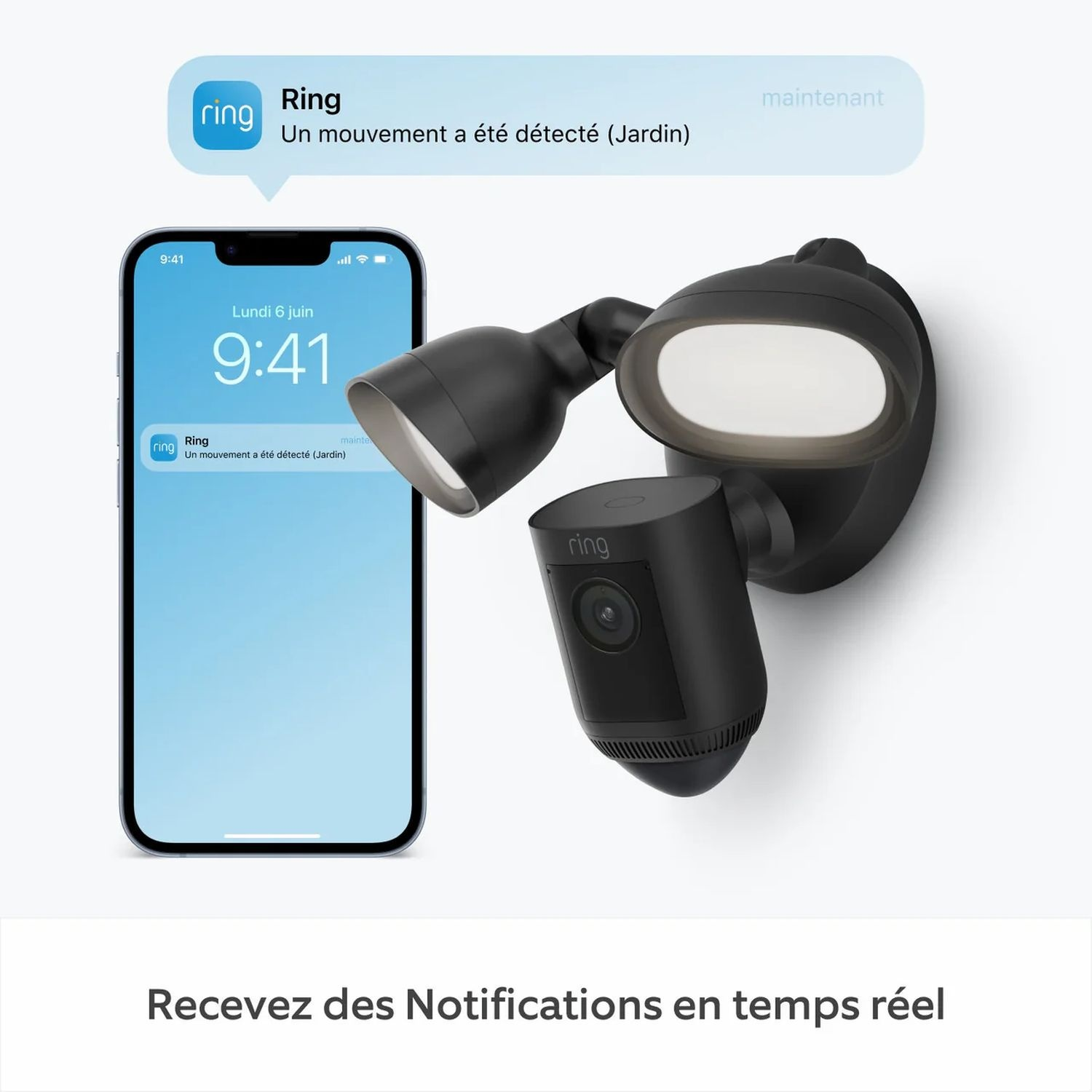 Un système de sécurité domestique intelligent noir avec un téléphone affichant une notification. Une caméra noire est fixée au mur.