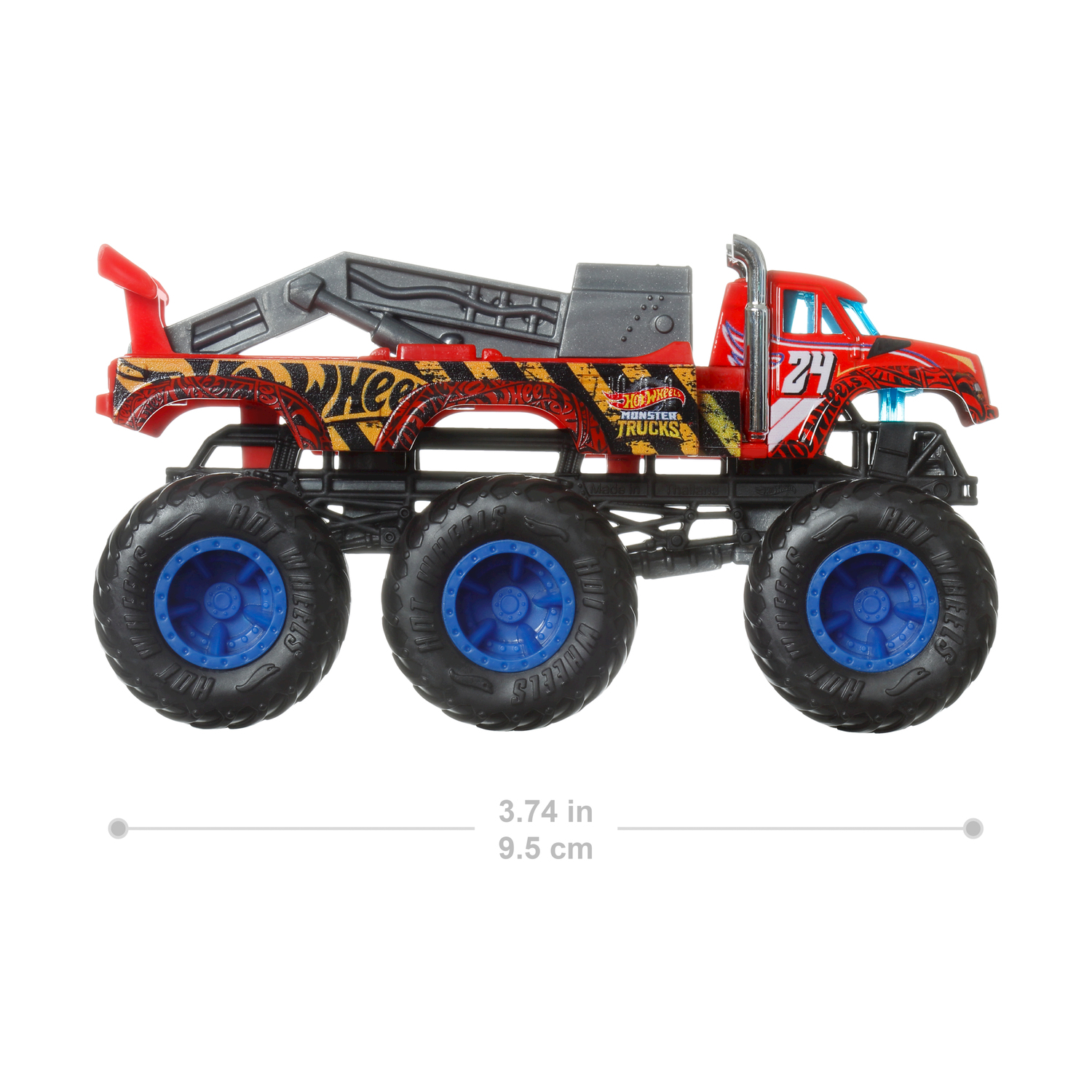 Camion mostro rosso giocattolo. Grandi ruote, braccio di traino e marchio 'Hot Wheels'.