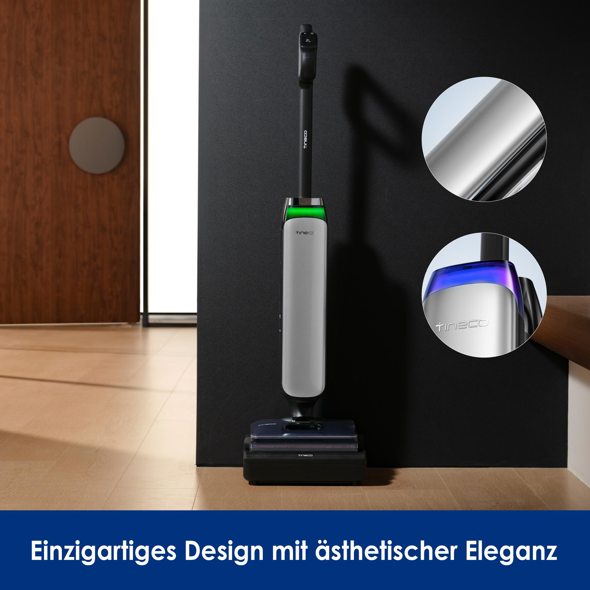 Ein silberner und schwarzer Staubsauger steht auf einem Holzboden. Das Design ist elegant.