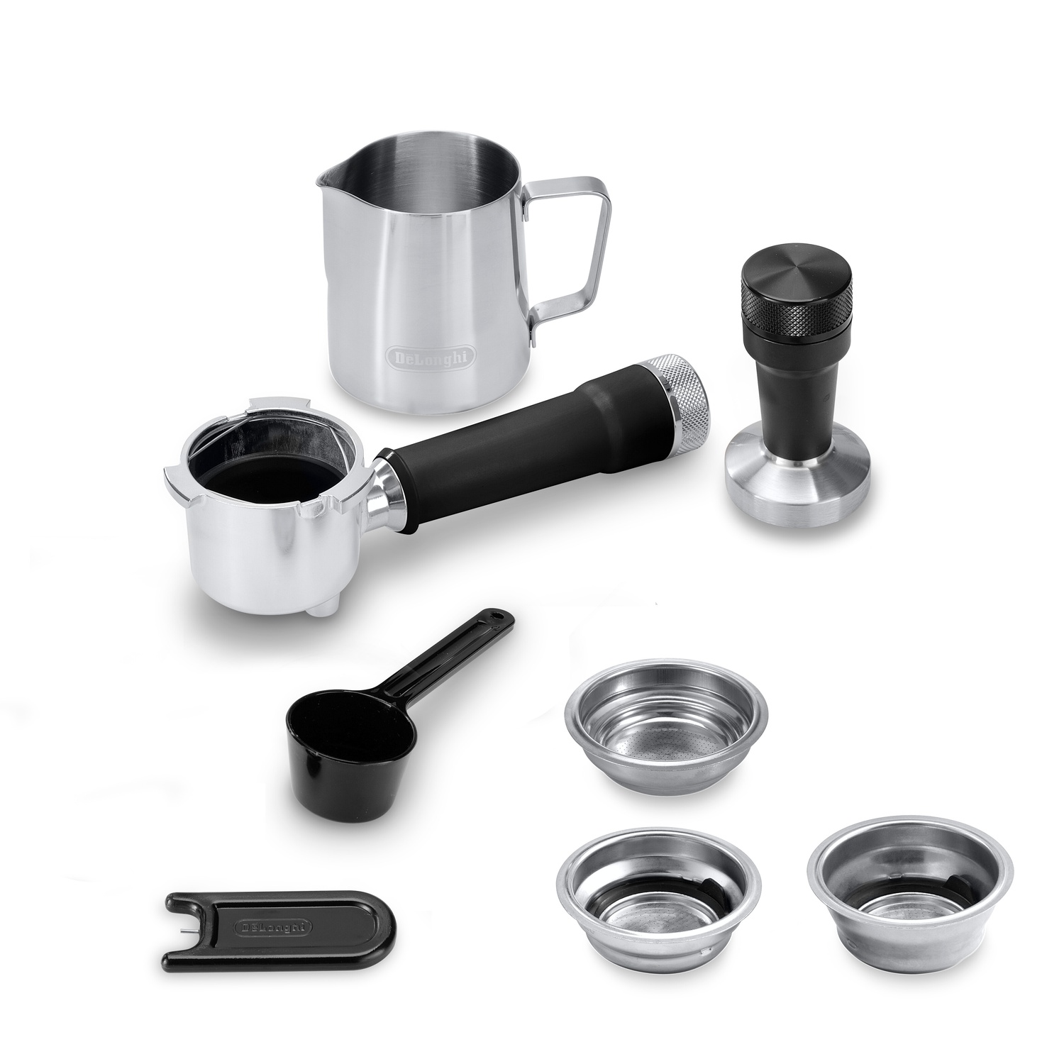 Espresso machine accessories: steel pitcher, tamper, portafilter, and several filter baskets.