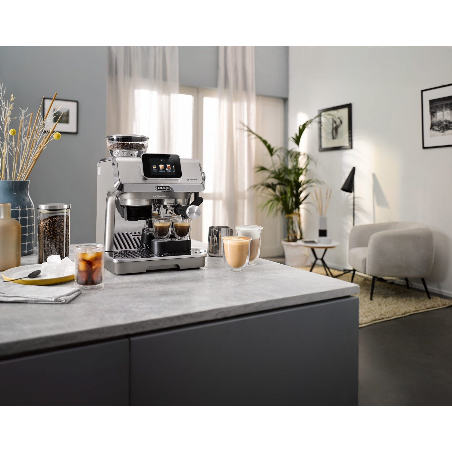 Coffee machine on a countertop with cups of coffee and a background scene.