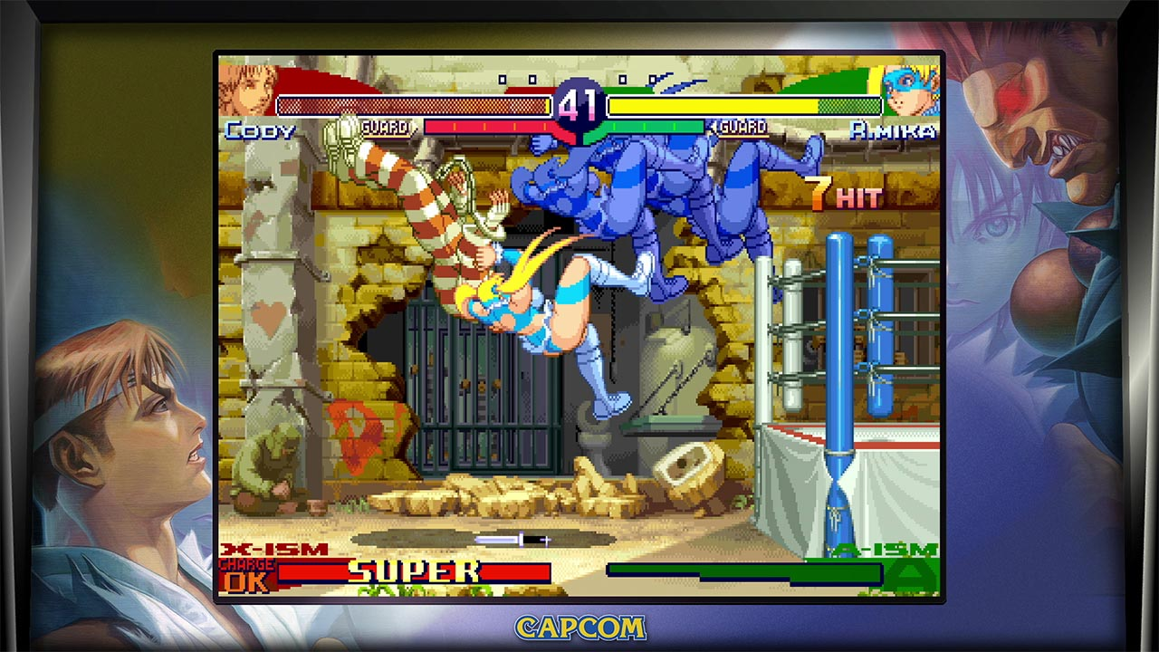 Scena di combattimento di un videogioco. Due personaggi stanno combattendo. Lo schermo mostra le barre della salute e le info di gioco. Cornice arcade.
