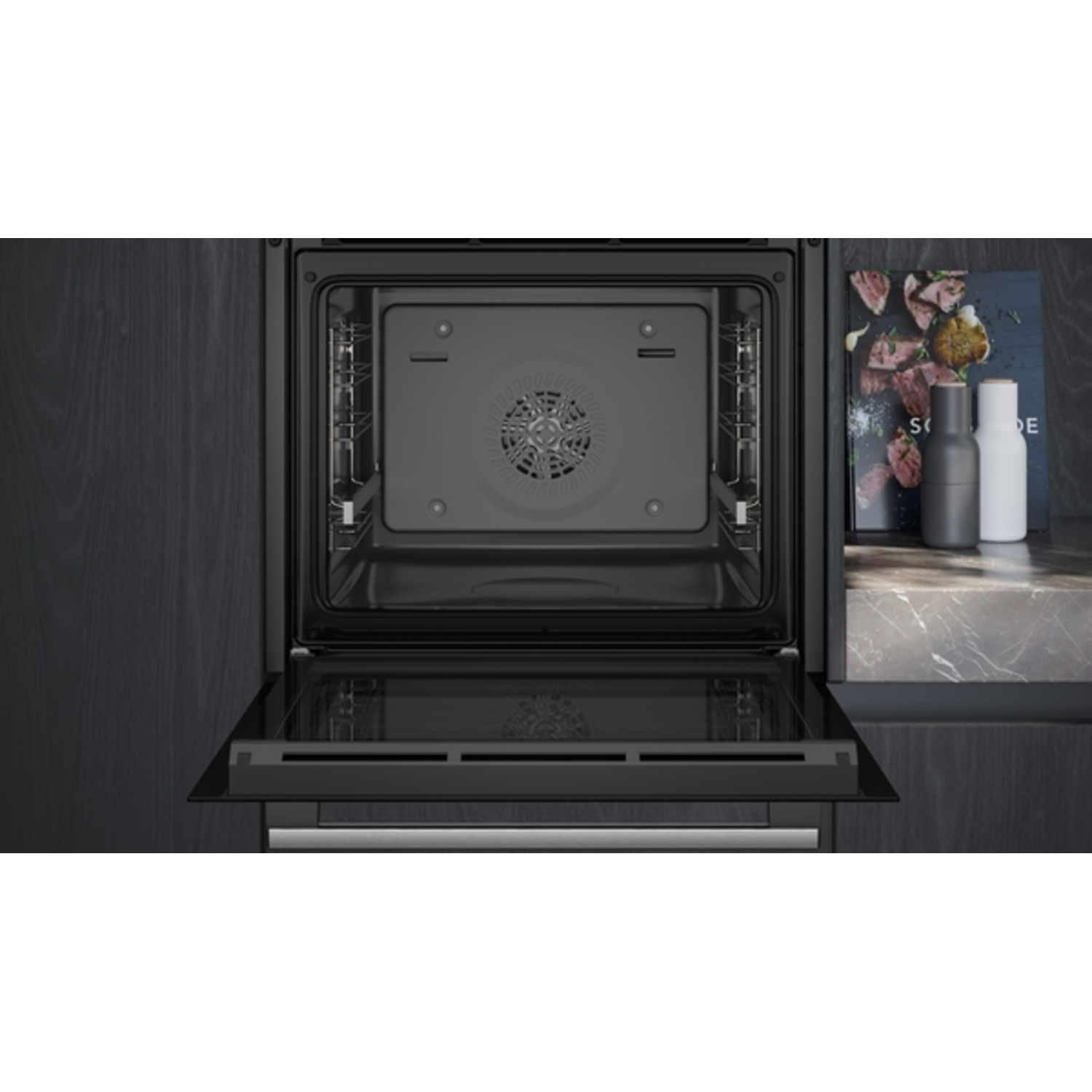 An open oven interior. There are shelves, a fan, and the door is slightly ajar.
