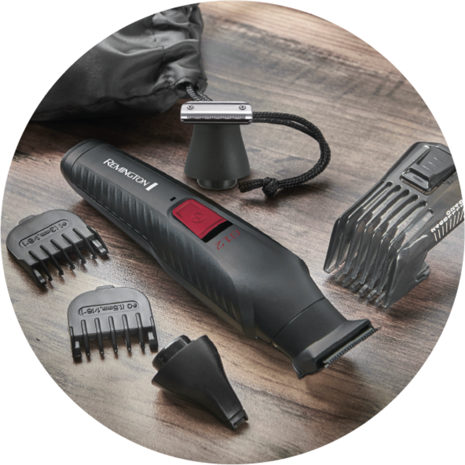 Black Remington trimmer with attachments on wood surface. A black bag is in the background.