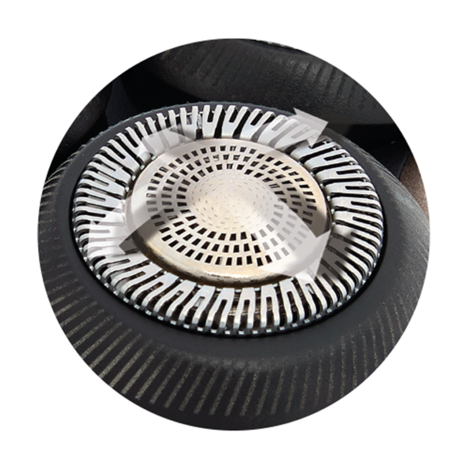 Close up of a circular shaver head, silver inner and a dark outer section.