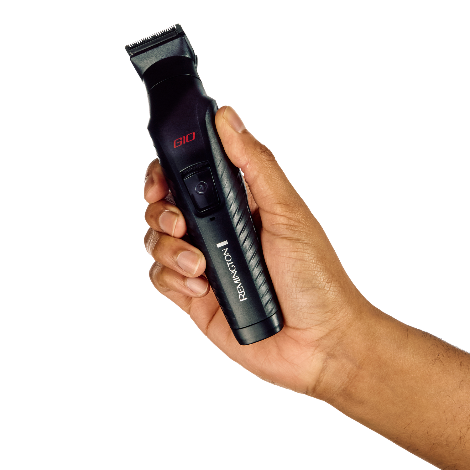 A hand holding a black Remington G10 trimmer, with red accents, against a white background.