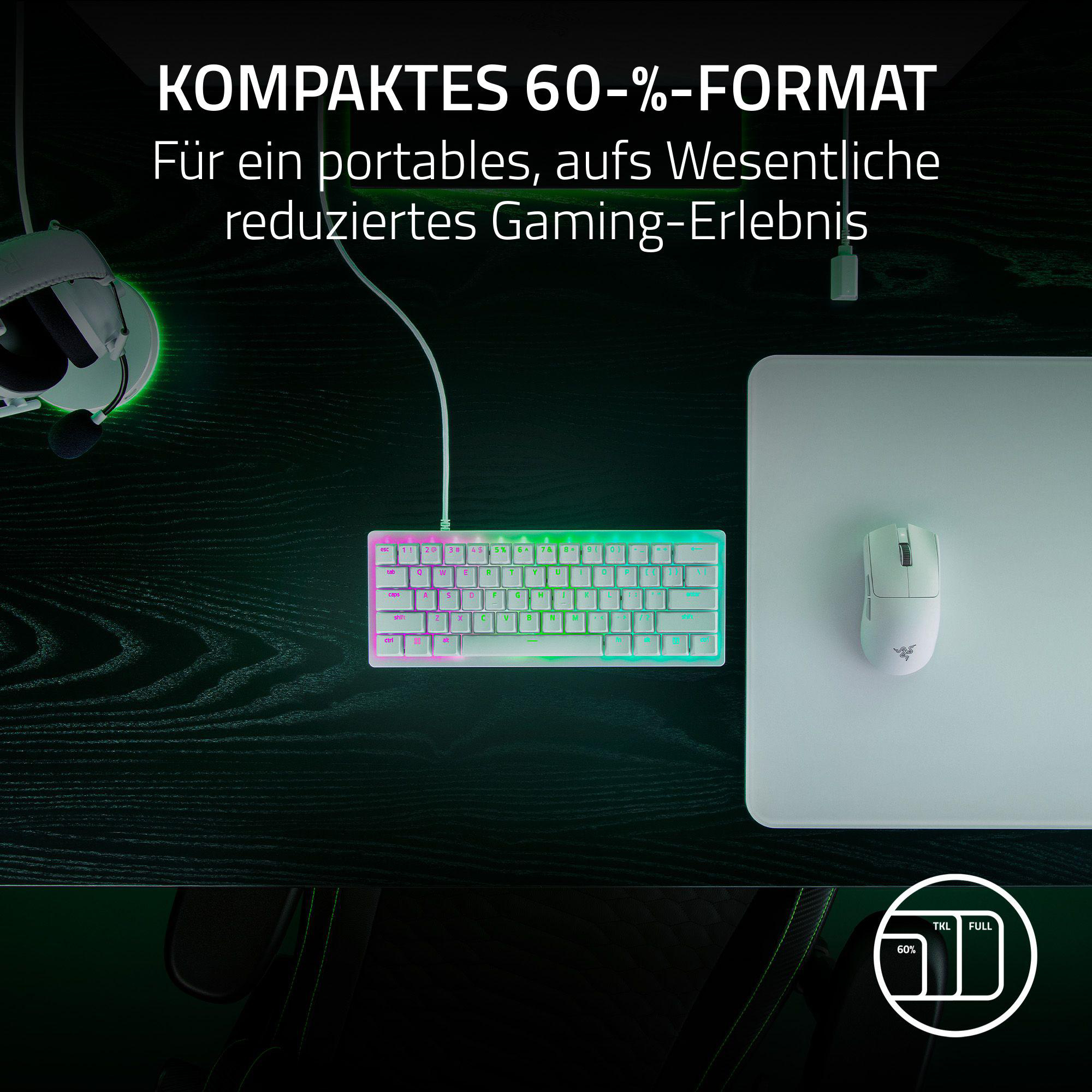 Tastatur, Maus und Mauspads auf einem Schreibtisch. Grün-schwarzes Farbschema.