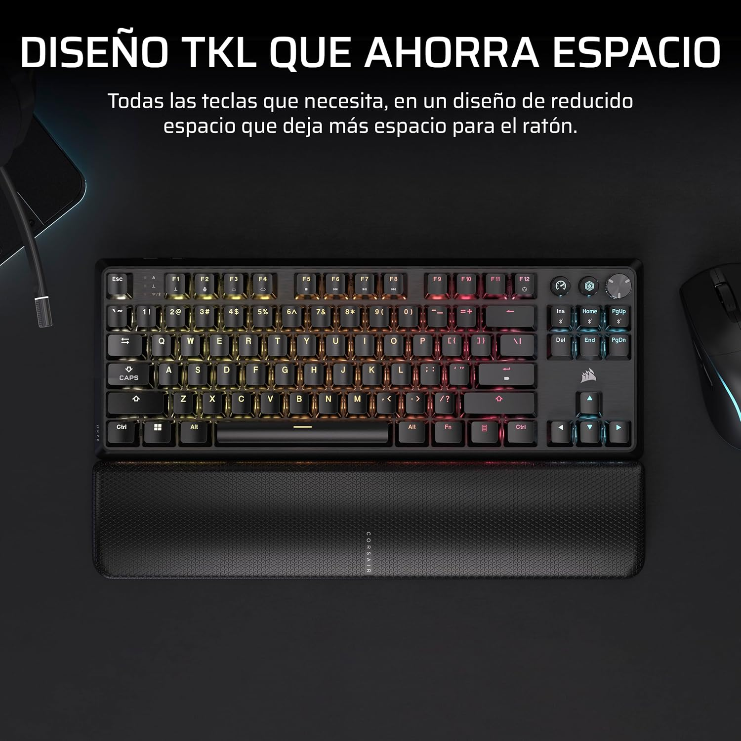 Teclado TKL negro con reposamuñecas y un efecto arcoíris iluminado.