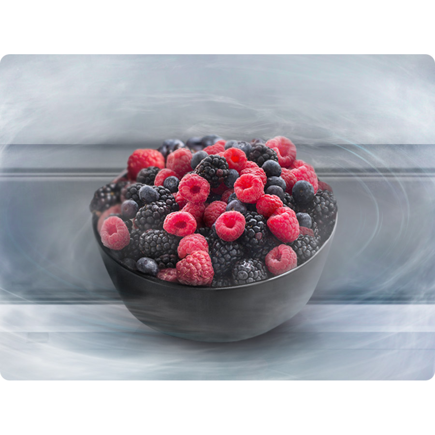 A bowl filled with mixed berries like raspberries, blackberries, and blueberries, placed in a foggy scene.