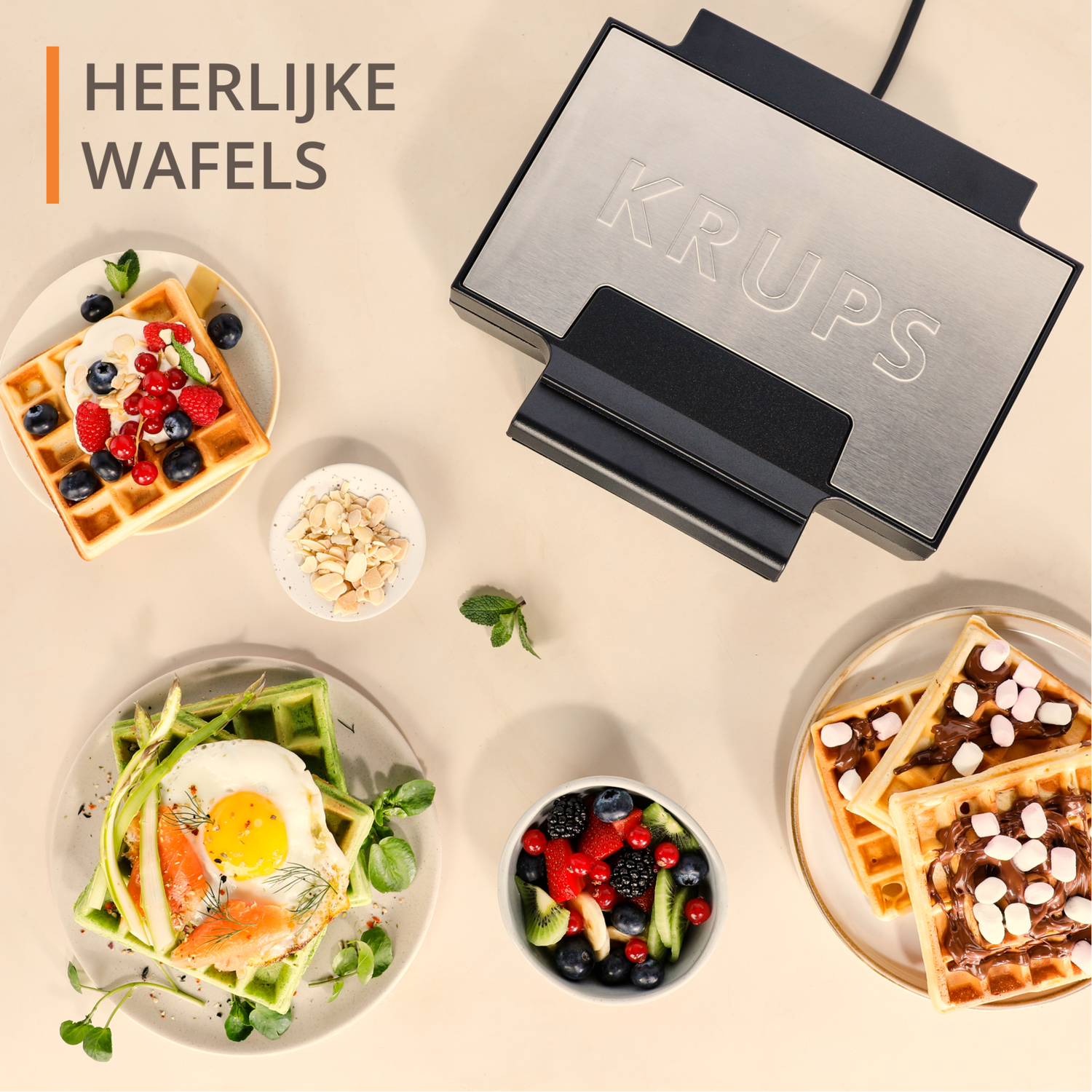 Various waffles with toppings and a Krups waffle maker on a light surface.
