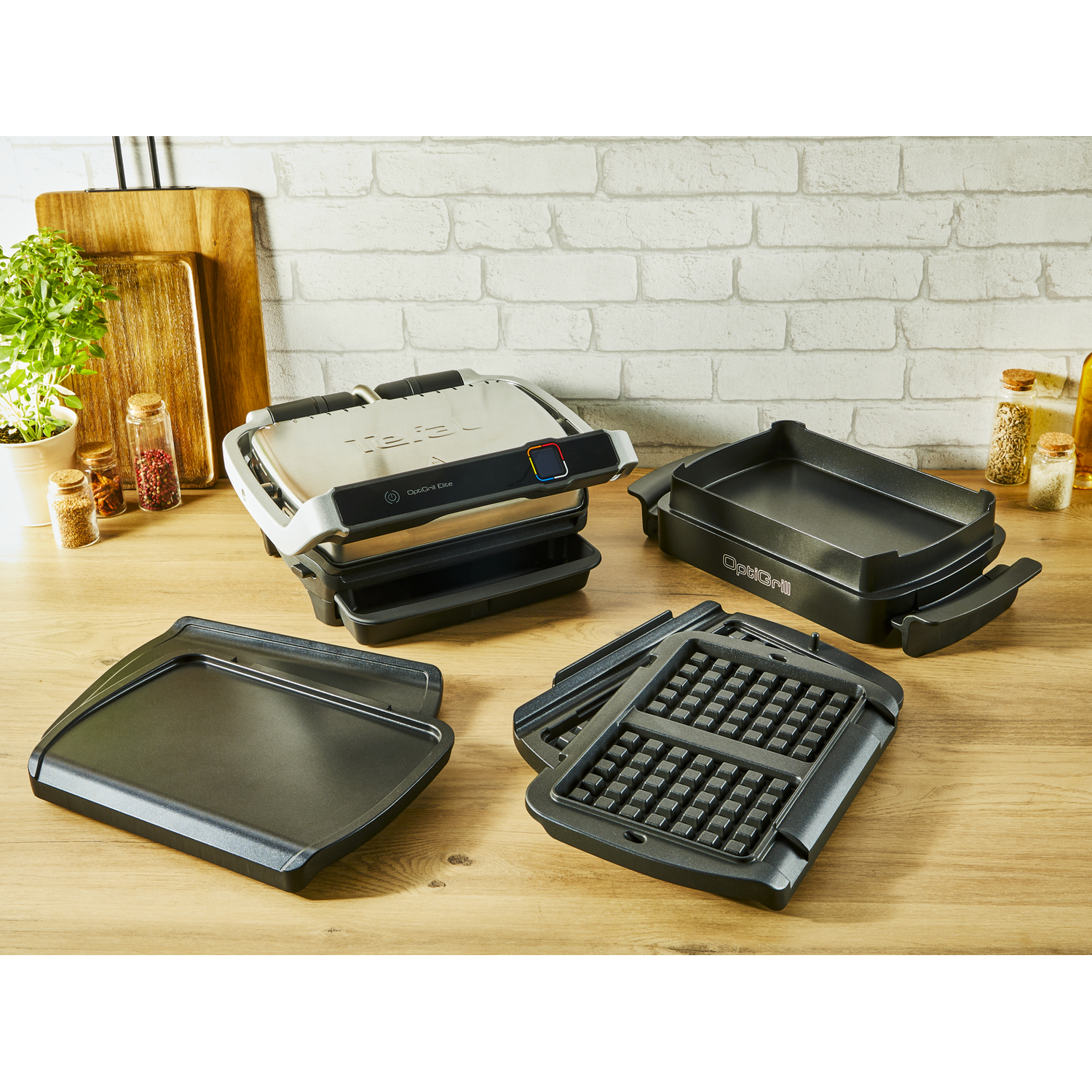 Grill with accessories on a wooden surface.