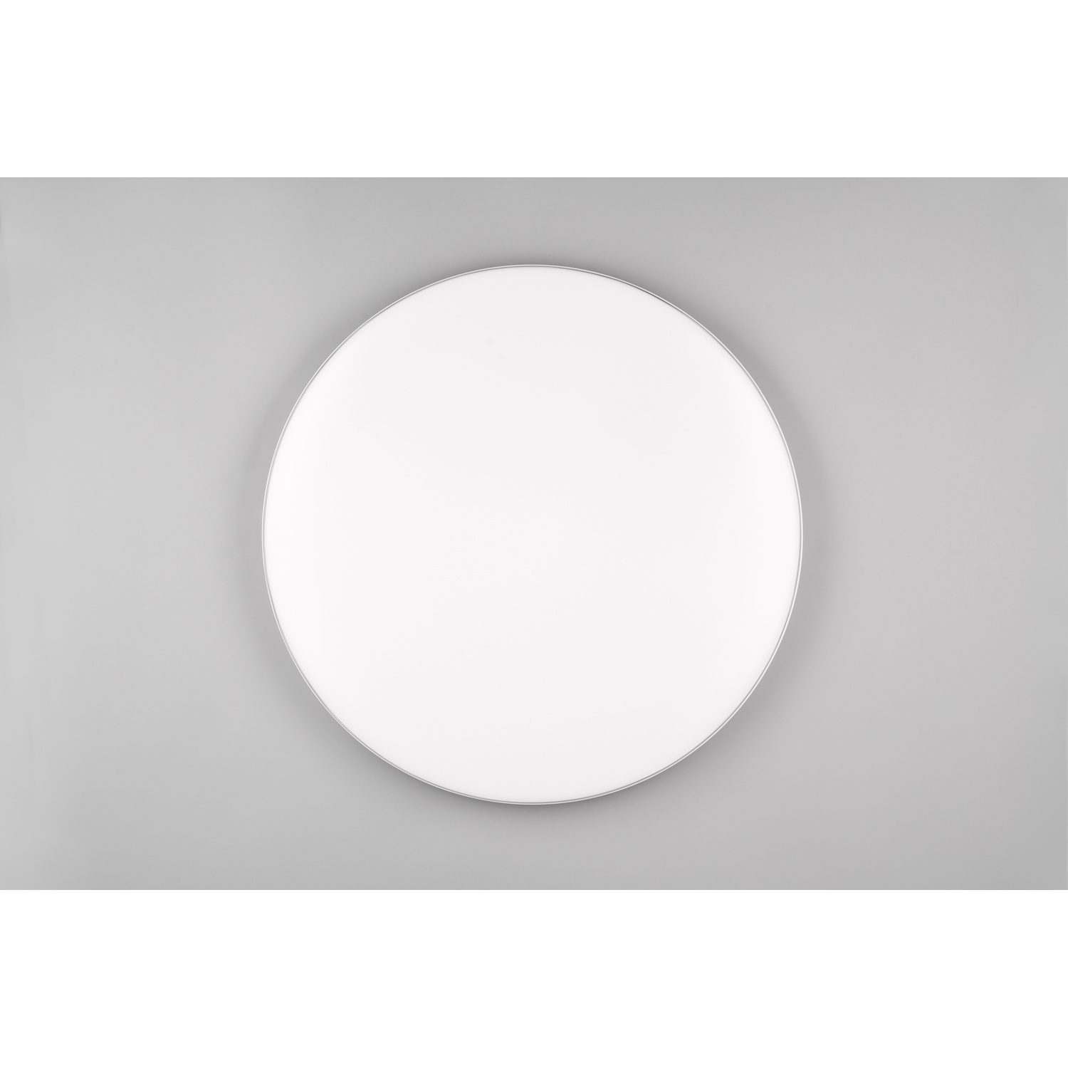 Pannello LED rotondo bianco su sfondo grigio, vista dall'alto.