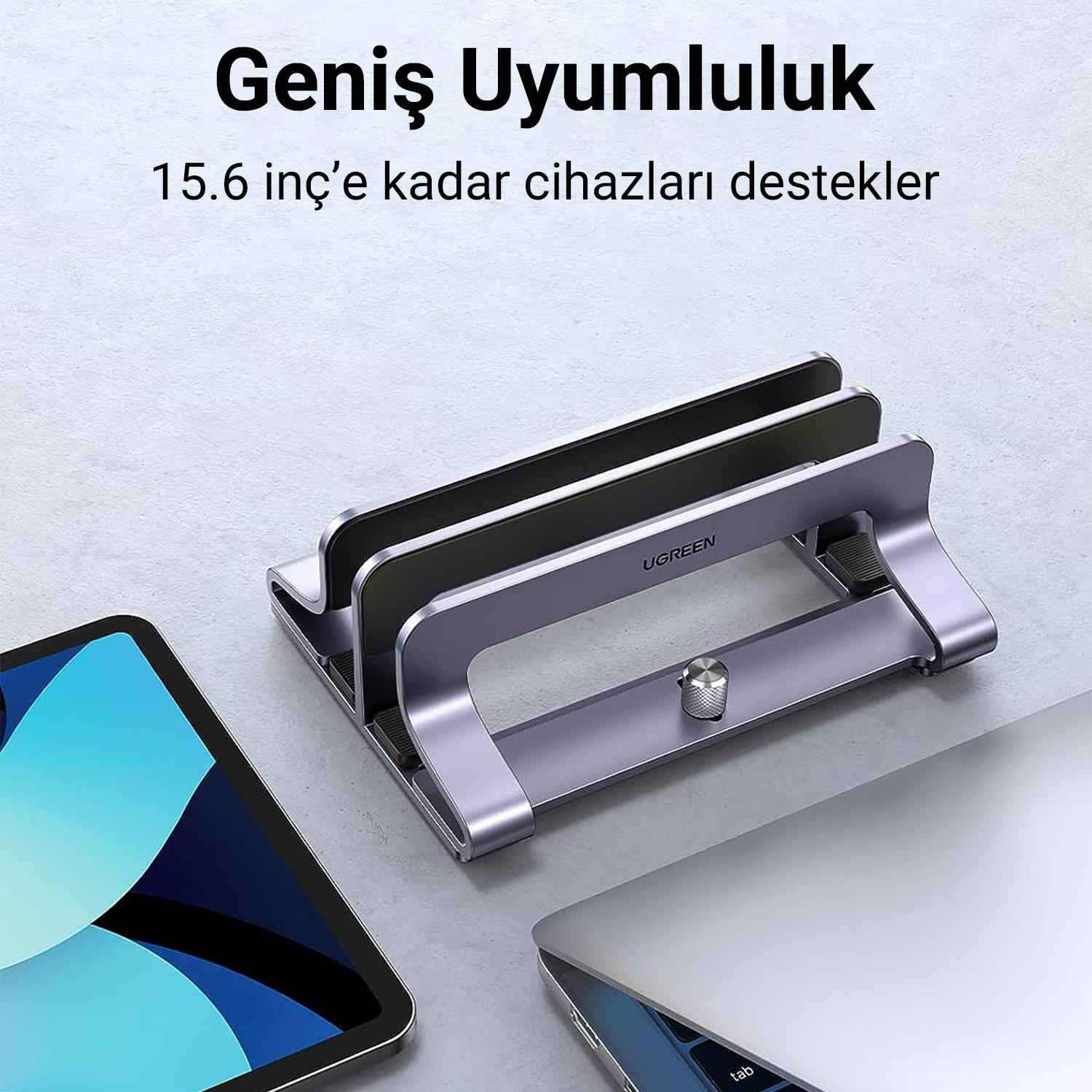 Bir tablet ve dizüstü bilgisayar tutan gümüş renkli bir cihaz. Metin: 'Genis Uyumululuk'.