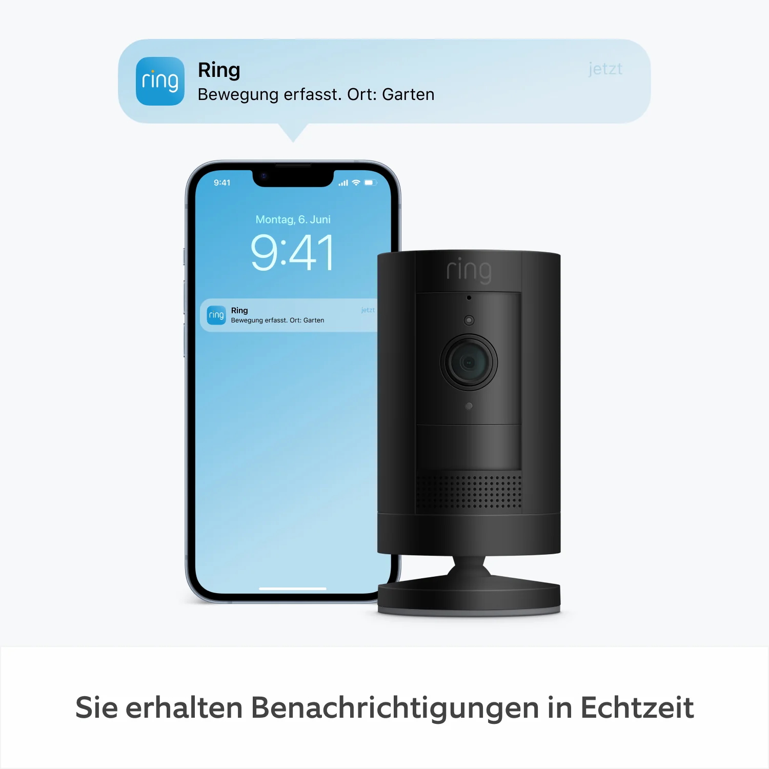 Eine schwarze Ring-Kamera neben einem Telefon, das eine Benachrichtigung zeigt. Die Benachrichtigung sagt: Ring, Bewegung erkannt.