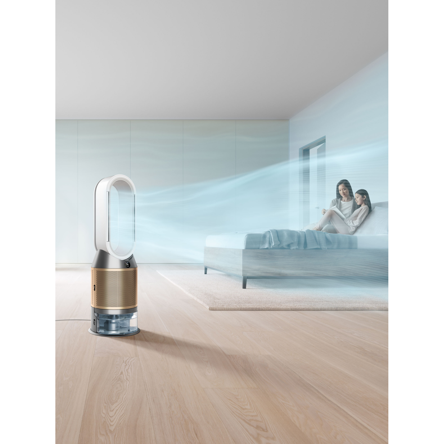 A modern air purifier near a bed with two women sitting.
