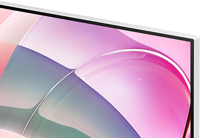 Zbliżenie ekranu monitora w białej ramie z abstrakcyjnymi różowymi i fioletowymi wzorami.