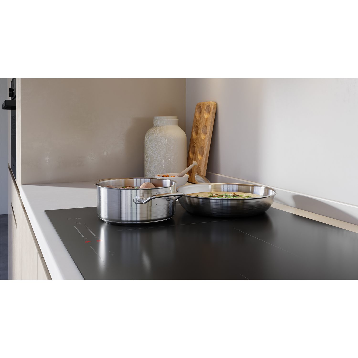 Kitchen scene with a stovetop, pans, and decorative items on the countertop.