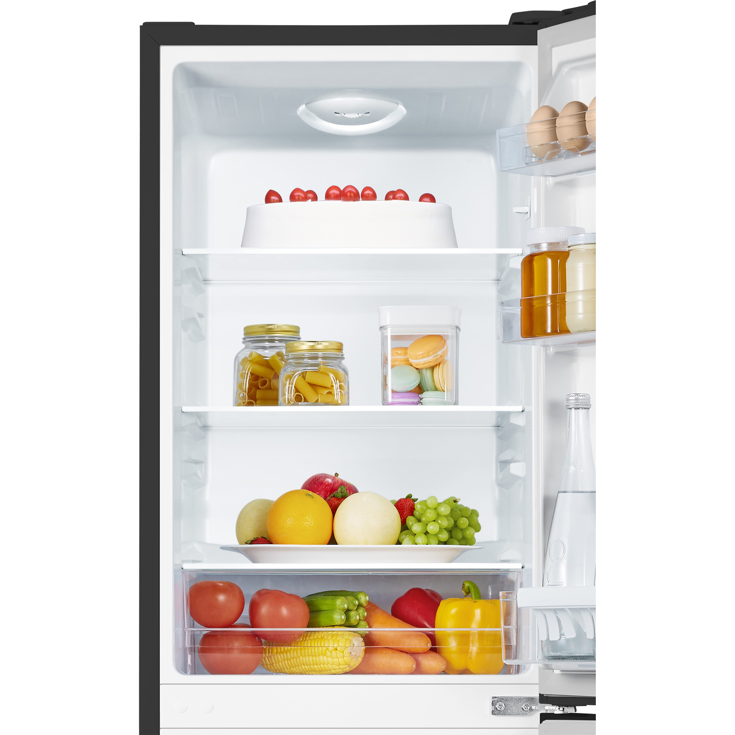 Opened refrigerator with shelves containing food items: fruits, vegetables, and jars.