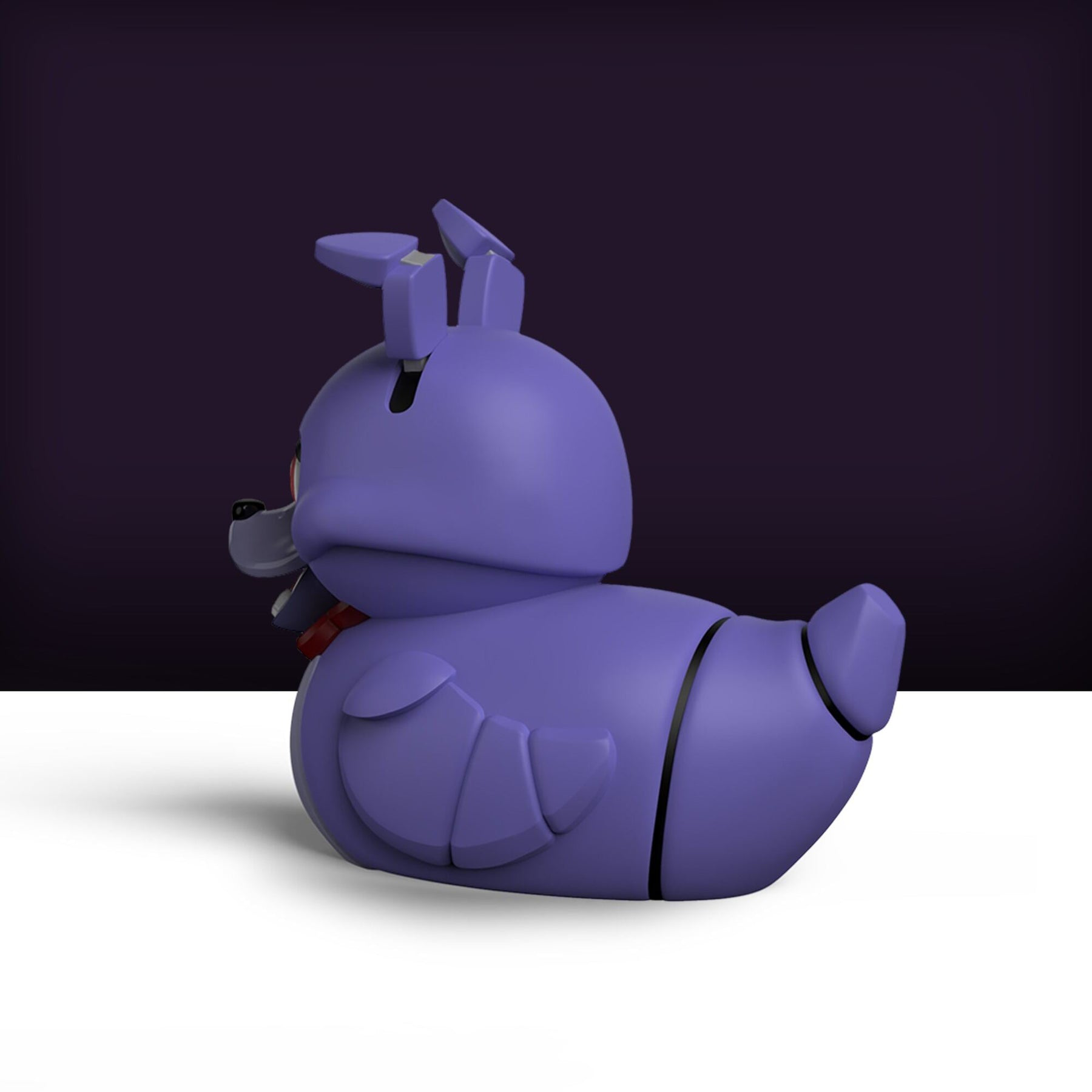 Egy lila Bonnie figura a Five Nights at Freddy's-ből, fehér felületen ül.