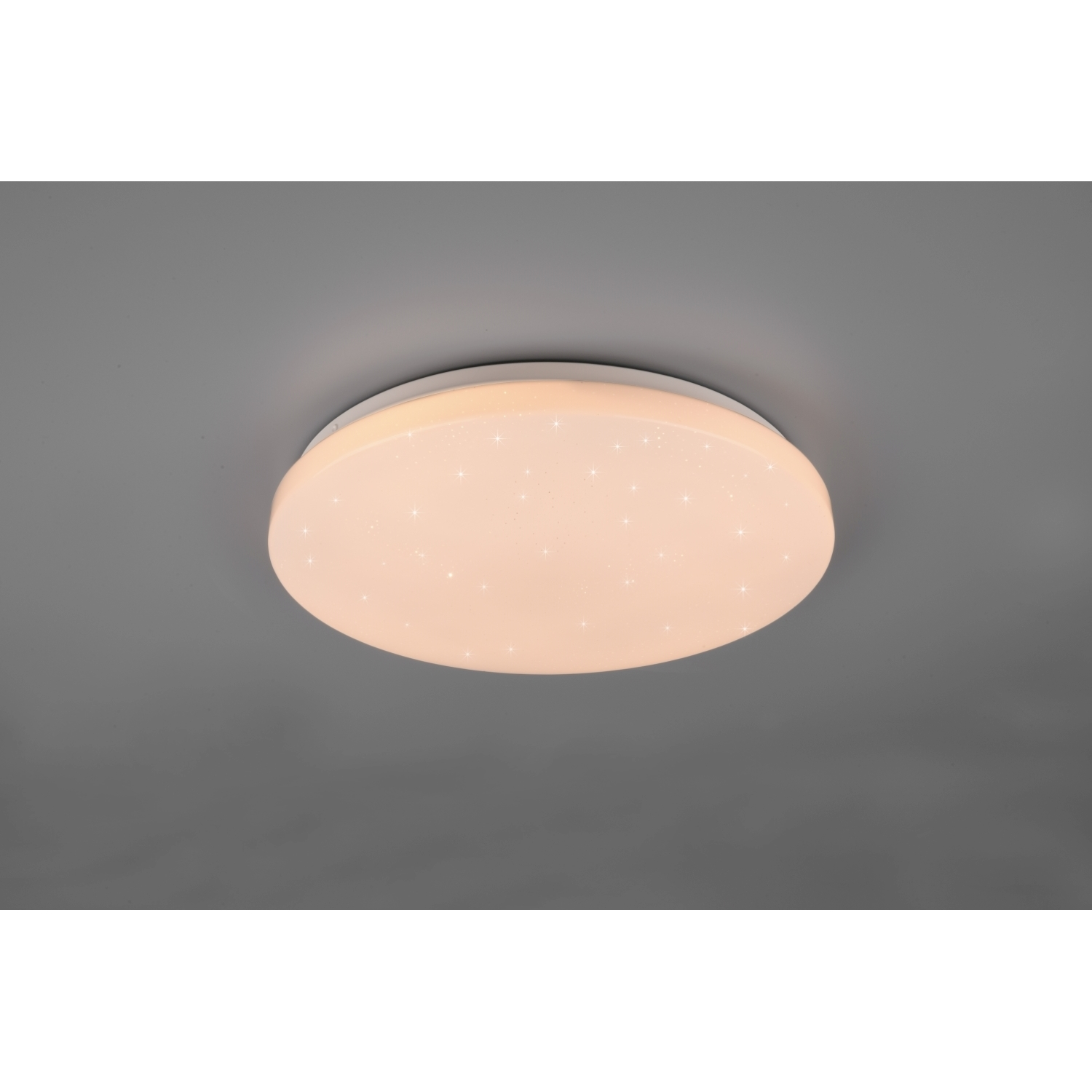 Plafoniera rotonda con cornice bianca e effetto stellato sulla luce.