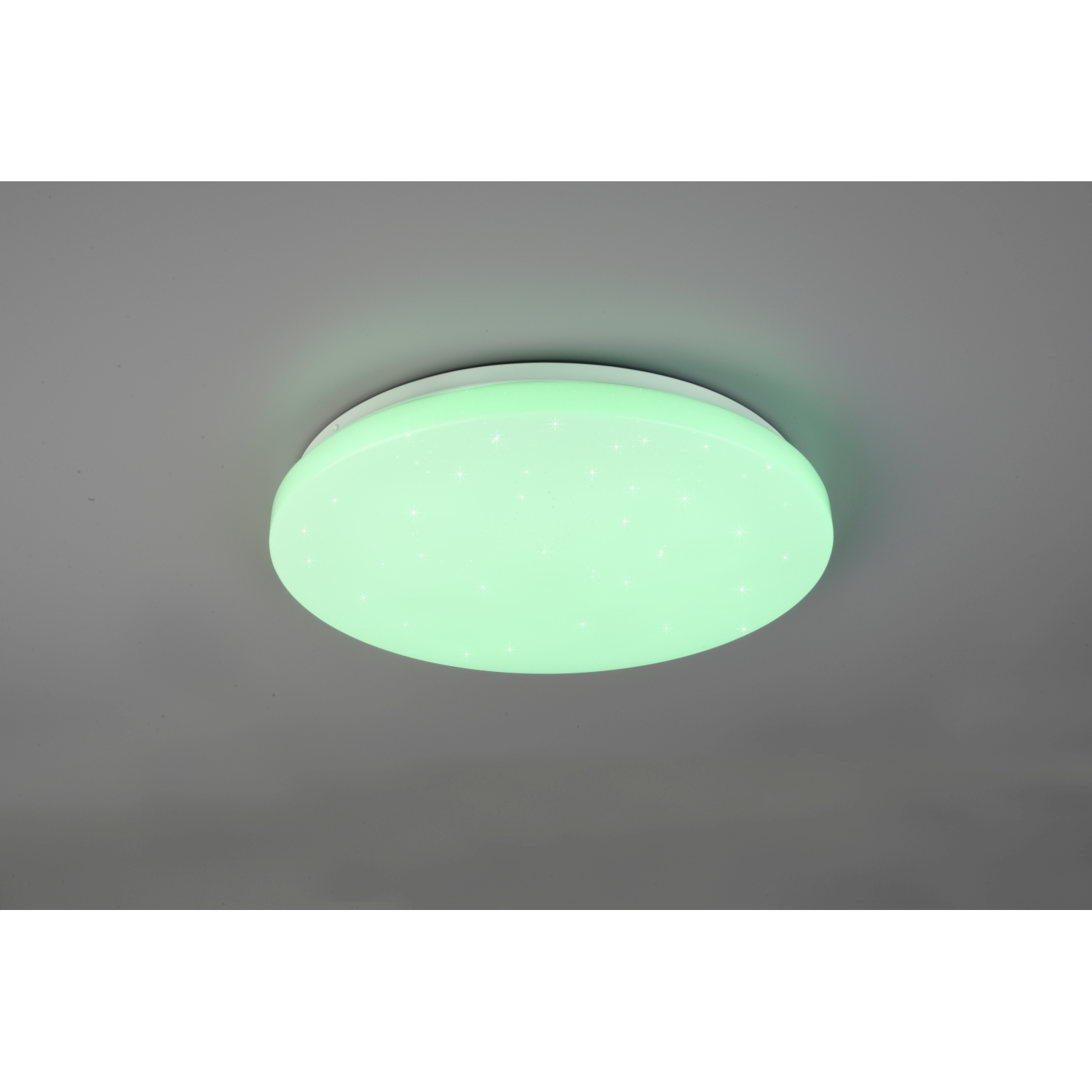 Lampada da soffitto rotonda che emette luce verde. La luce è su un soffitto grigio con alcune stelle.