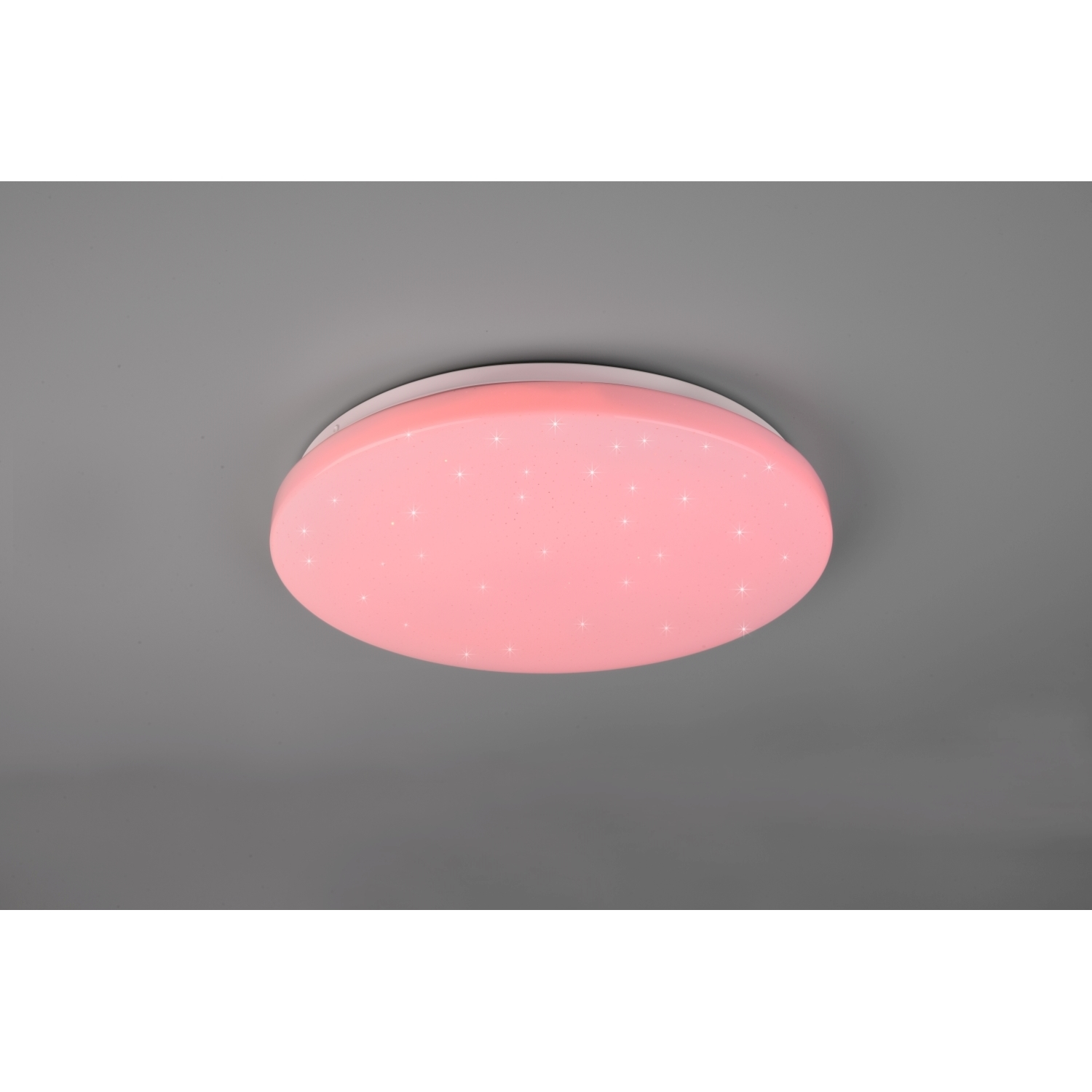 Una lampada da soffitto circolare rosa con luci a forma di stella incorporate su sfondo grigio.