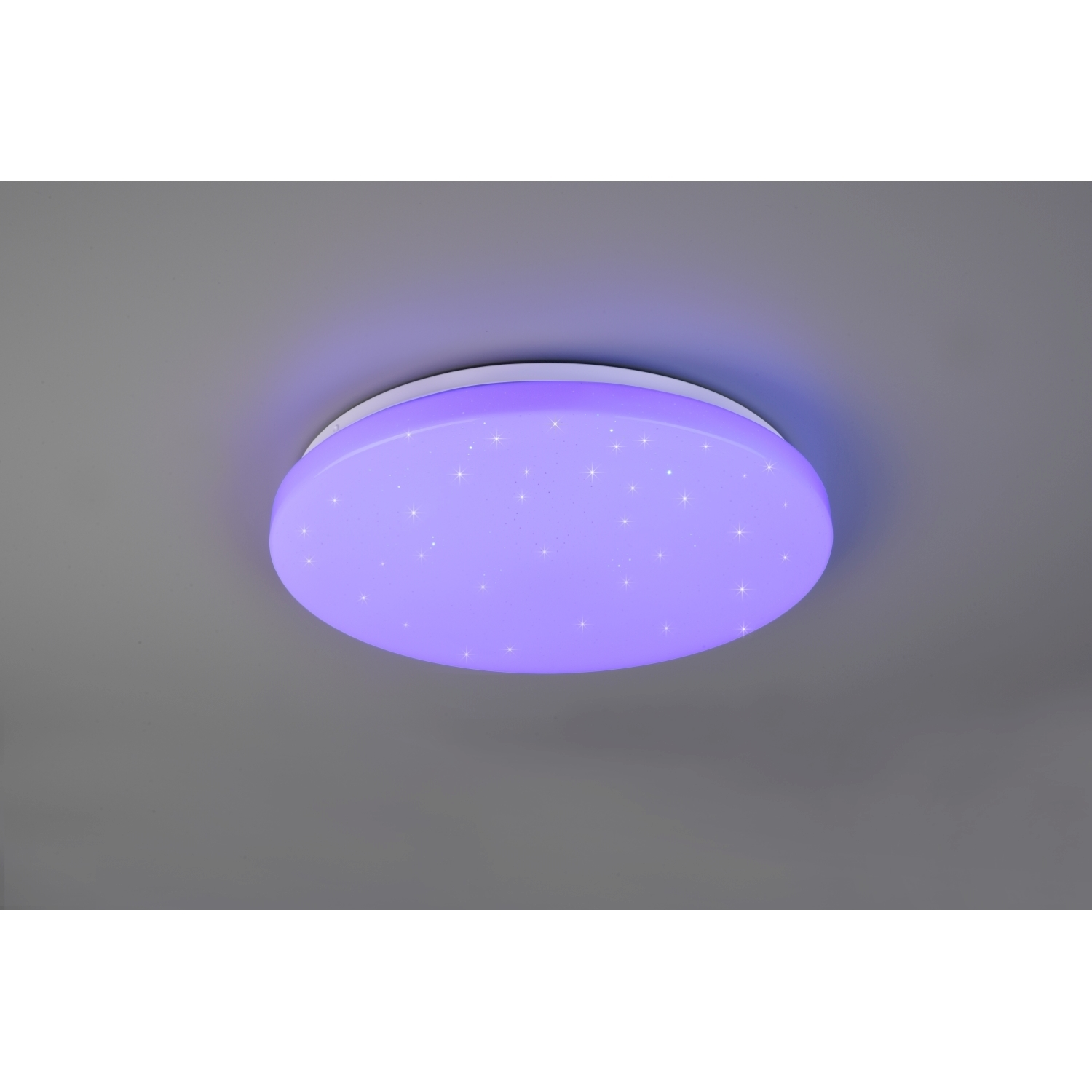 Lampada da soffitto rotonda che emette luce viola. La luce è su un soffitto grigio con alcune stelle.