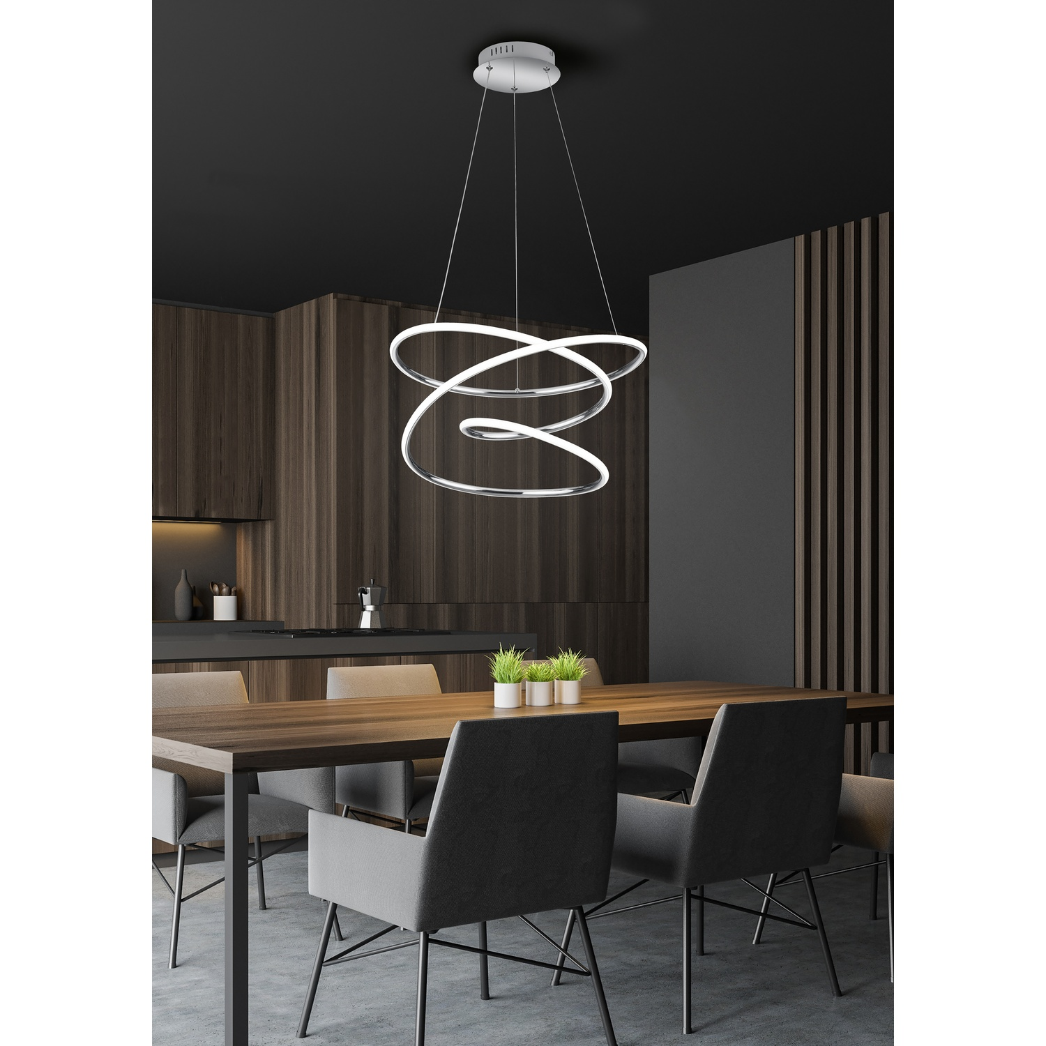 Lampadario moderno con design a spirale, appeso sopra un tavolo di legno in una sala da pranzo.