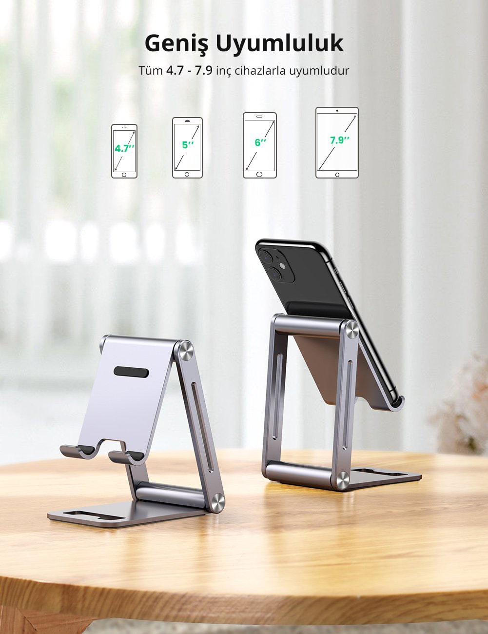 Telefon standı ve telefonlar. Telefon boyutu uyumluluğunu gösterir. Ahşap masa.