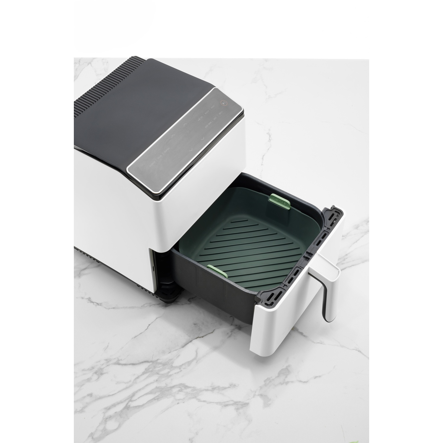 Air fryer with open drawer. White and black. Marble countertop.