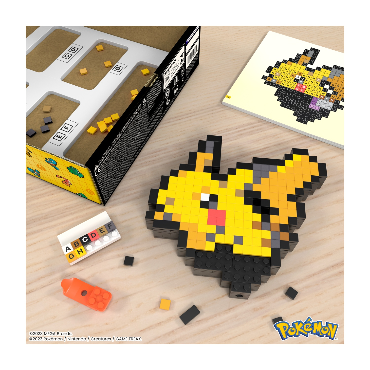 Pixel art di Pikachu fatto con blocchi, scatola aperta e blocchi sparsi.