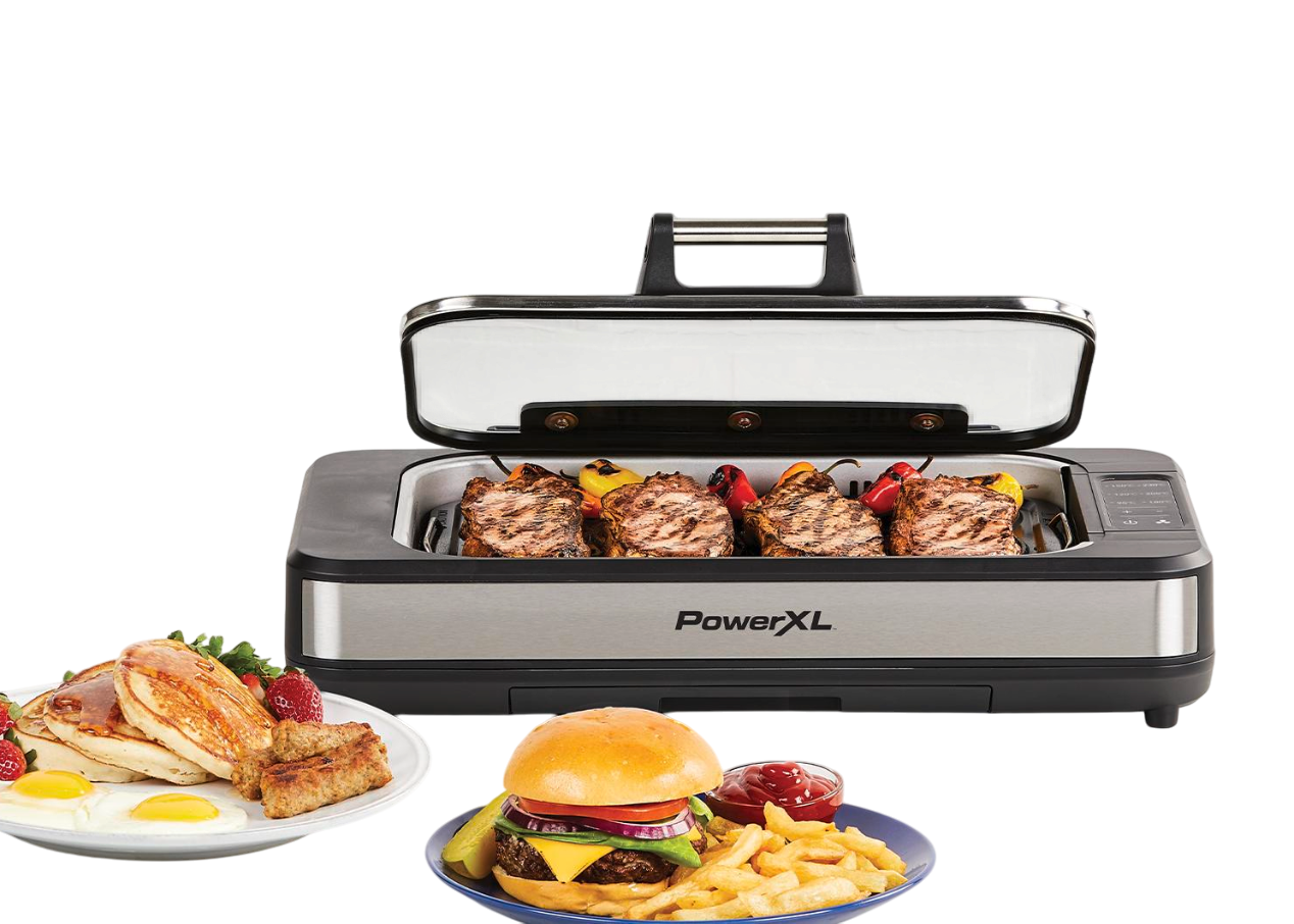 Ein offener Innengrill mit gegrilltem Essen und Tellern mit Essen auf schwarzem Hintergrund.