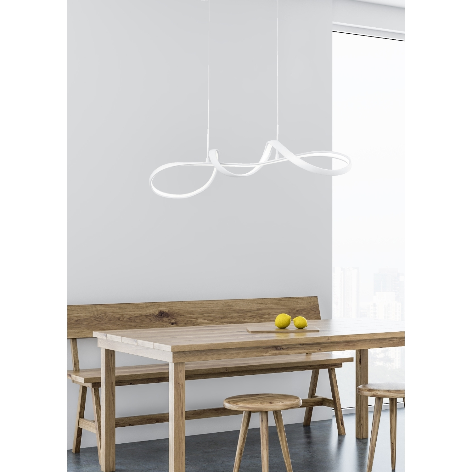 Lampadario bianco curvo sopra tavolo in legno, due limoni. Panca e sgabelli in legno.