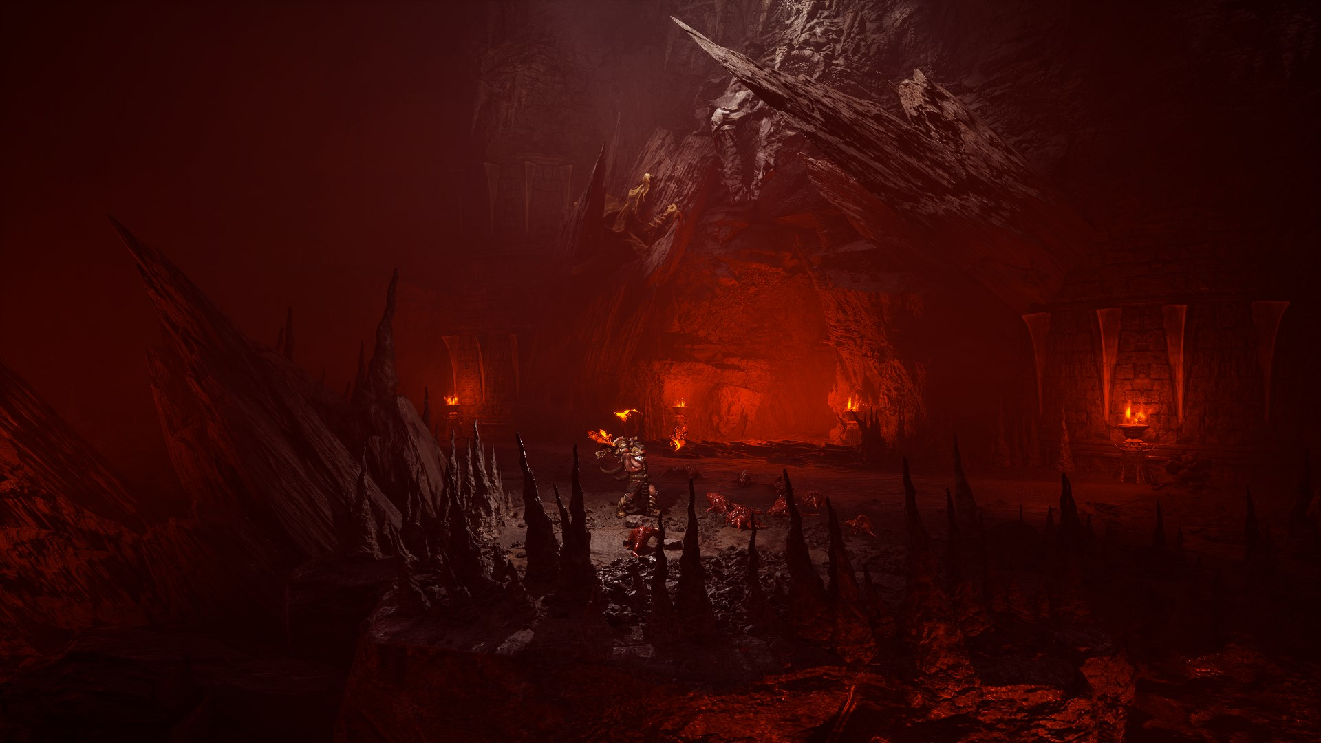 Grotte rouge avec torches et formations rocheuses. Ambiance sombre avec lueur ardente.