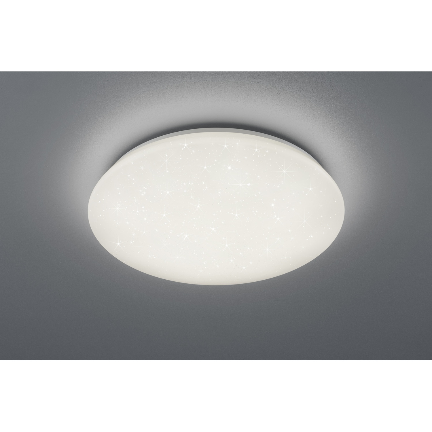 Plafoniera rotonda bianca con un design a stelle, montata su un soffitto grigio.