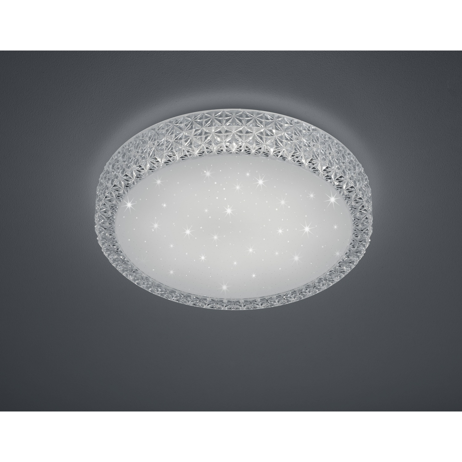 Plafoniera rotonda con un centro stellato e illuminato e un bordo a motivi a forma di cristallo.