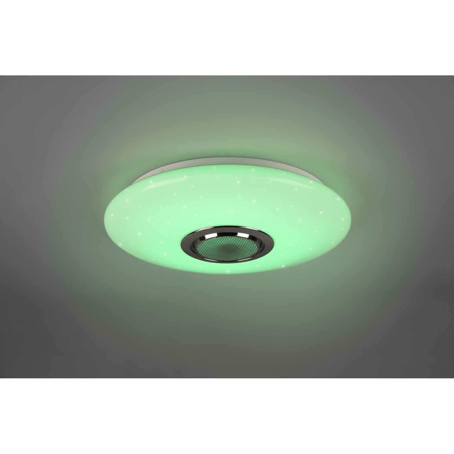 Una lampada da soffitto rotonda. La lampada emette luce verde con motivi a forma di stella.