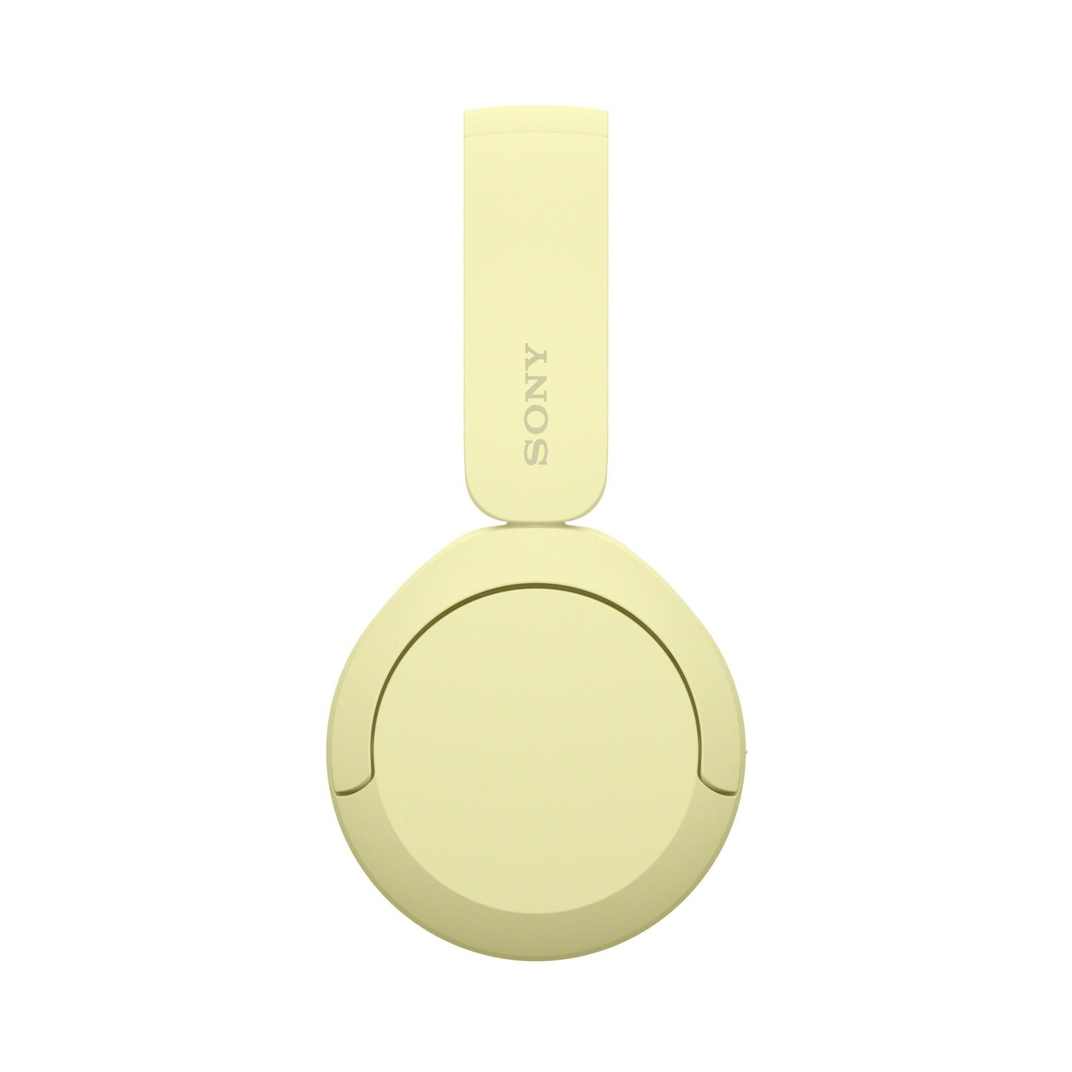 Vue de dessus d'un casque Sony jaune sur fond blanc. Les oreillettes sont rondes.