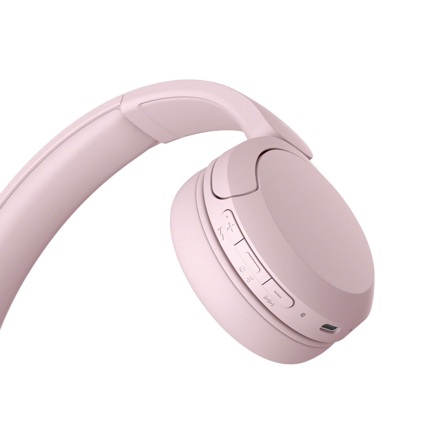 Casque sans fil rose. Commandes sur l'écouteur droit. Fond blanc.