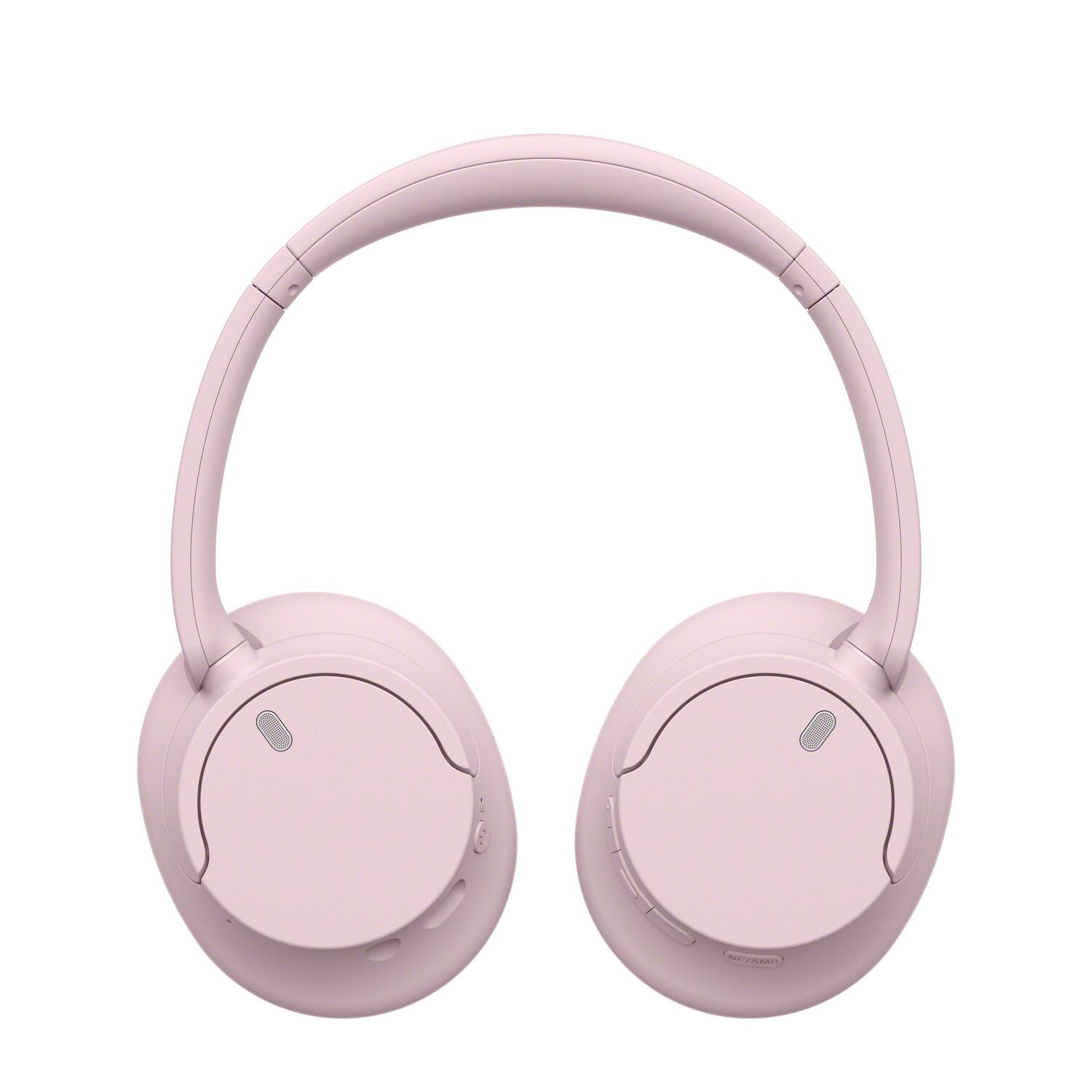 Casque rose sur fond blanc. Caractéristiques de conception sur les oreillettes et le bandeau.