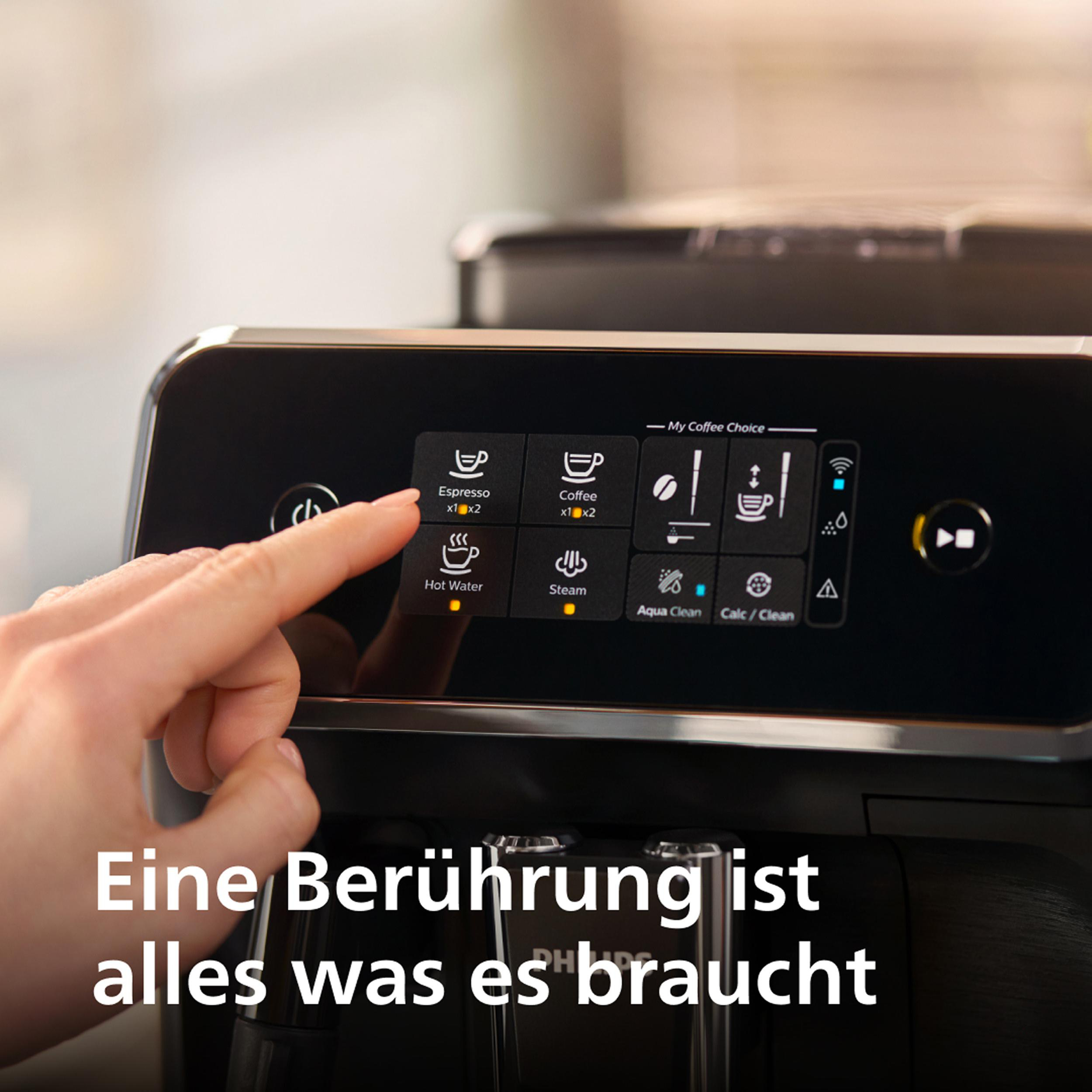 Eine Hand berührt den Touchscreen einer Kaffeemaschine. Text: 'Eine Berührung ist alles was es braucht'.