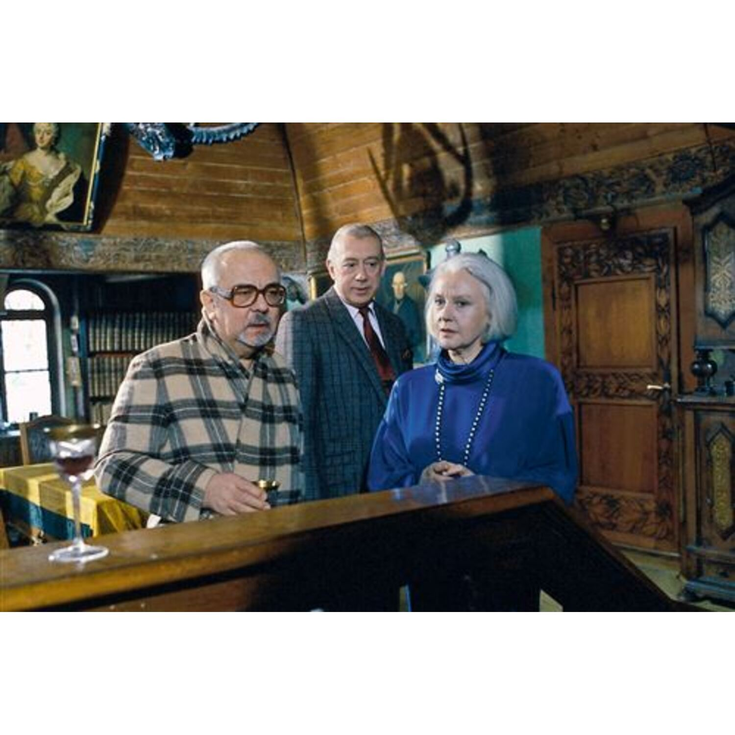 Three people in a vintage room.
