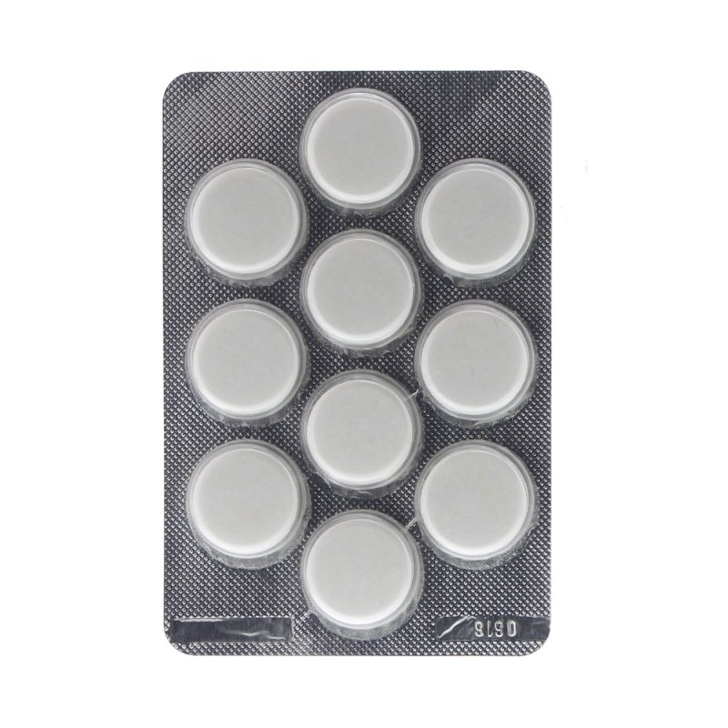 Un blíster de pastillas blancas, dispuestas en filas sobre un fondo plateado.