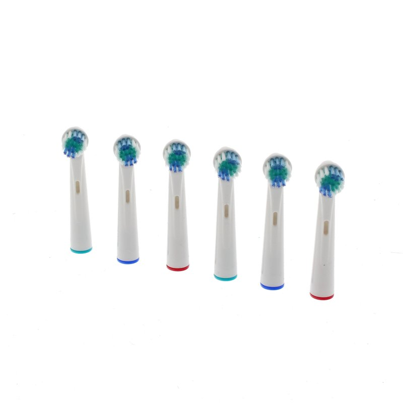 Seis cabezales de cepillo de dientes blancos con cerdas azules y verdes. Anillos de color.