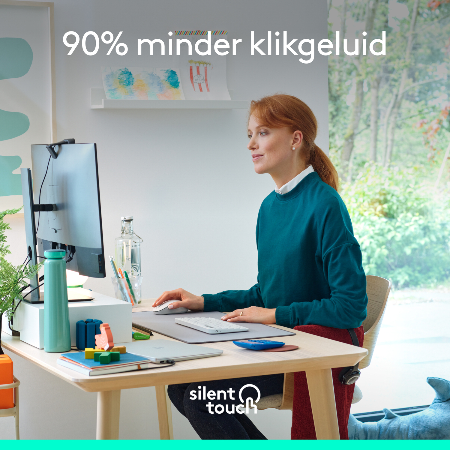 Woman working at a desk with a computer, keyboard and a mouse. The text says silent touch.