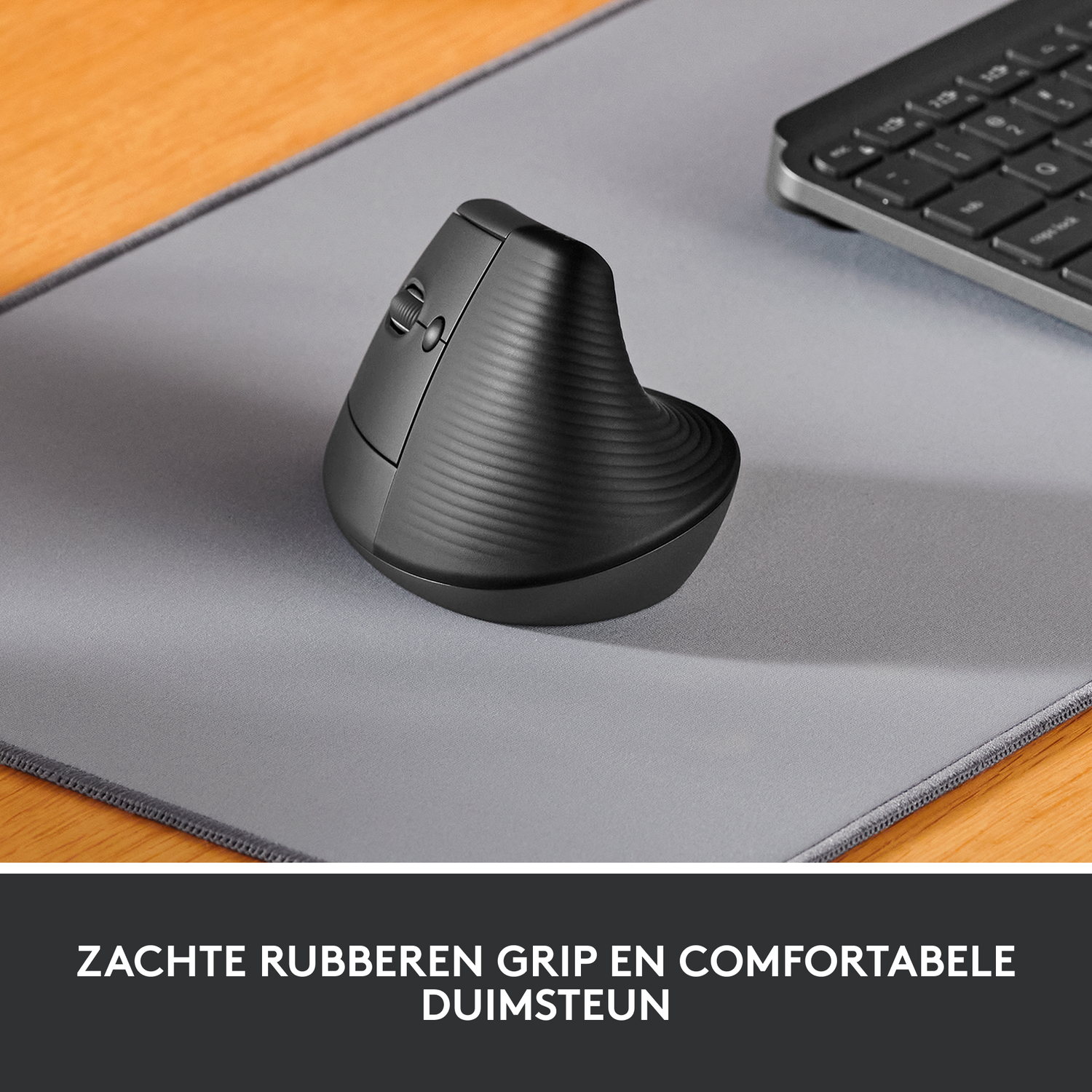 Black ergonomic mouse on a gray mousepad with a wooden background.