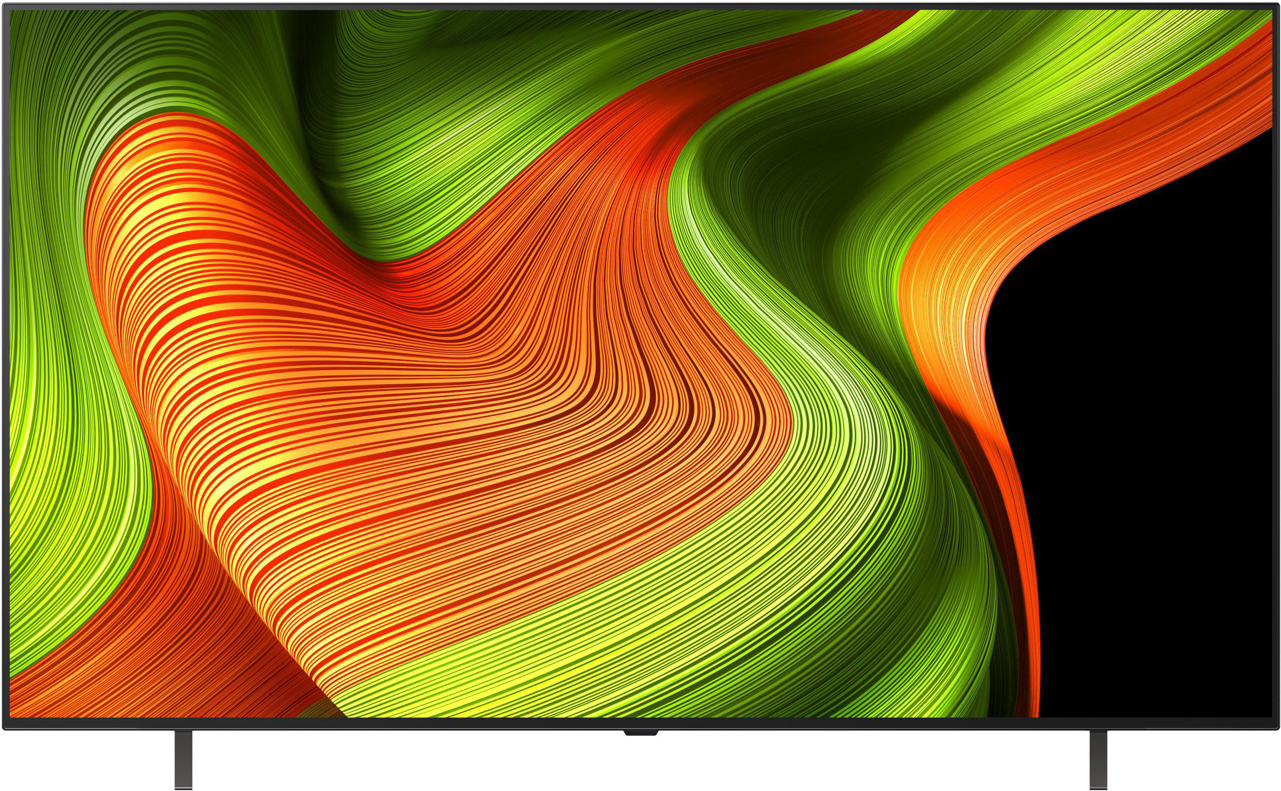 TV zeigt abstraktes Design mit grünen, orangefarbenen und gelben geschwungenen Linien auf schwarzem Hintergrund.