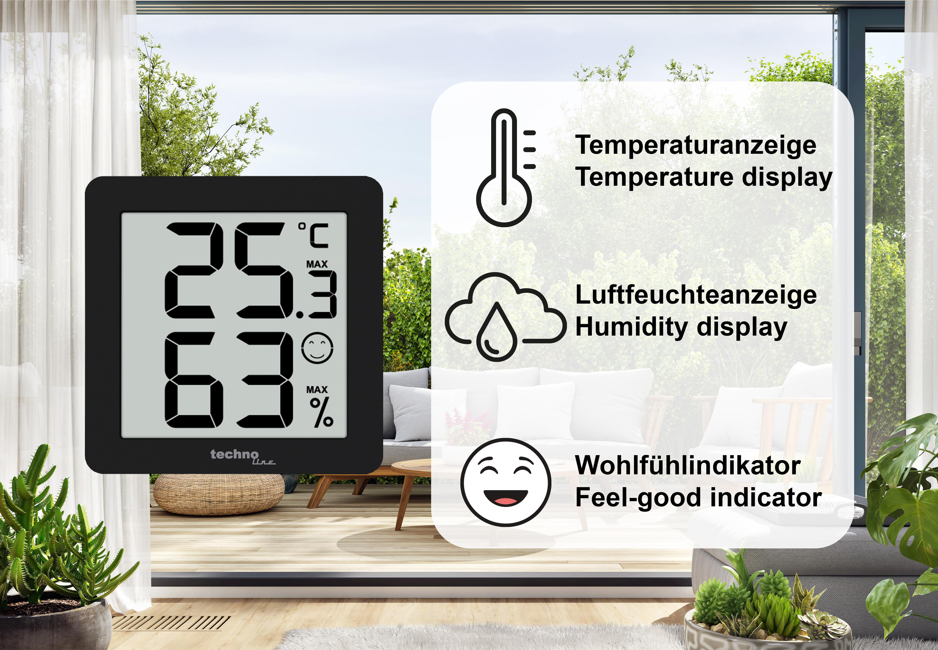 Digitale Wetterstation mit Temperatur, Luftfeuchtigkeit und Wohlfühlindikator, mit Gartenblick.